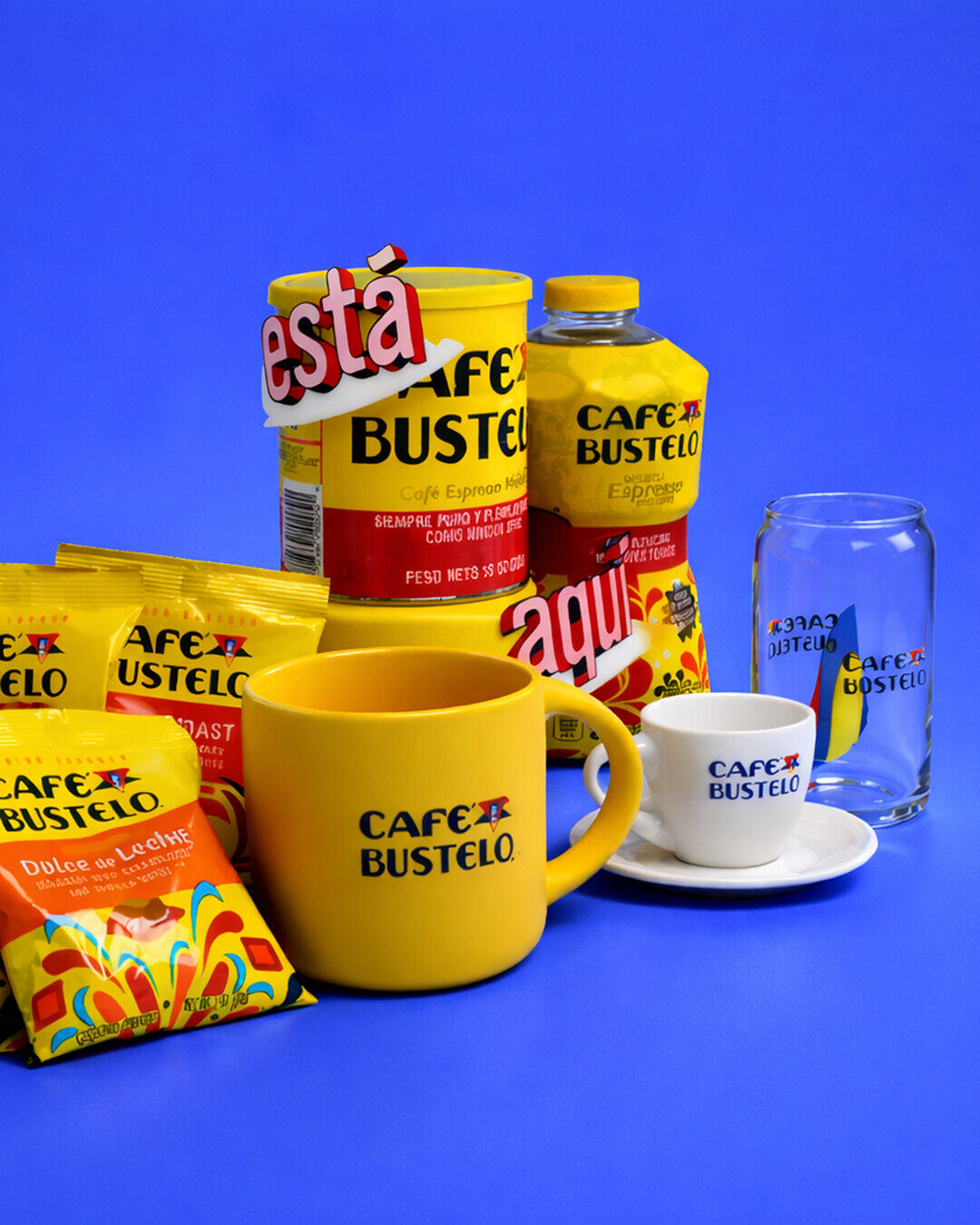 Café Bustelo product assortment with coffee, mugs and glassware on blue