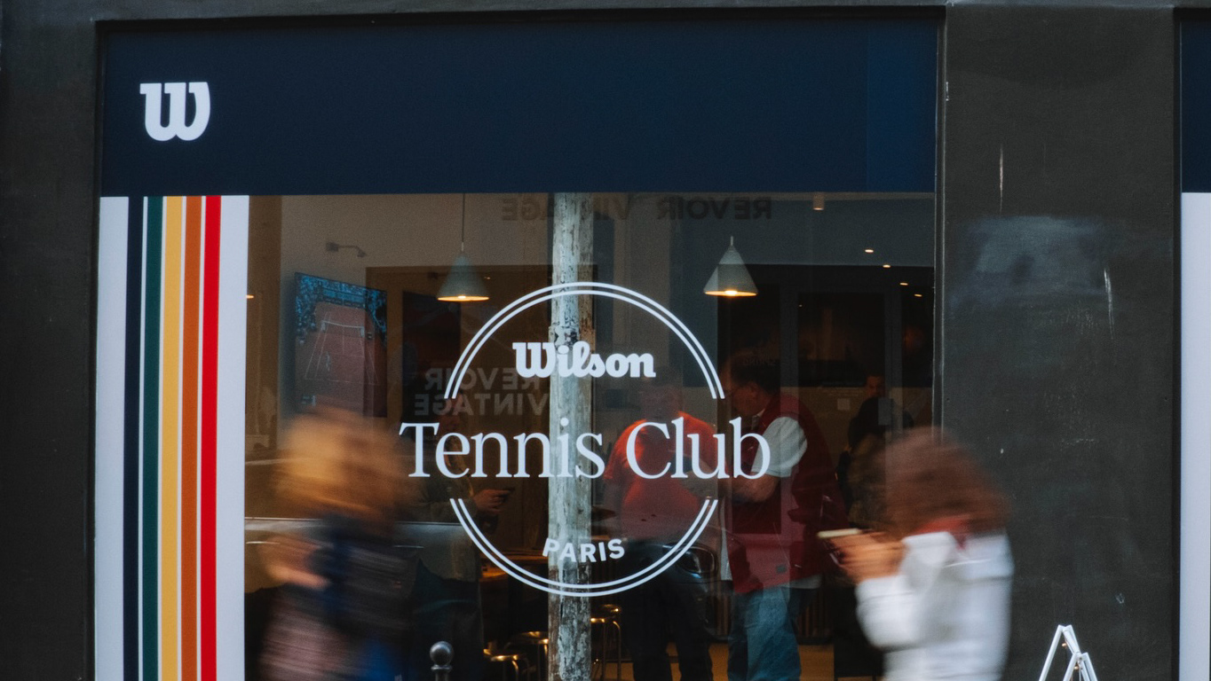 Wilson Tennis Club Paris storefront with guests moving past