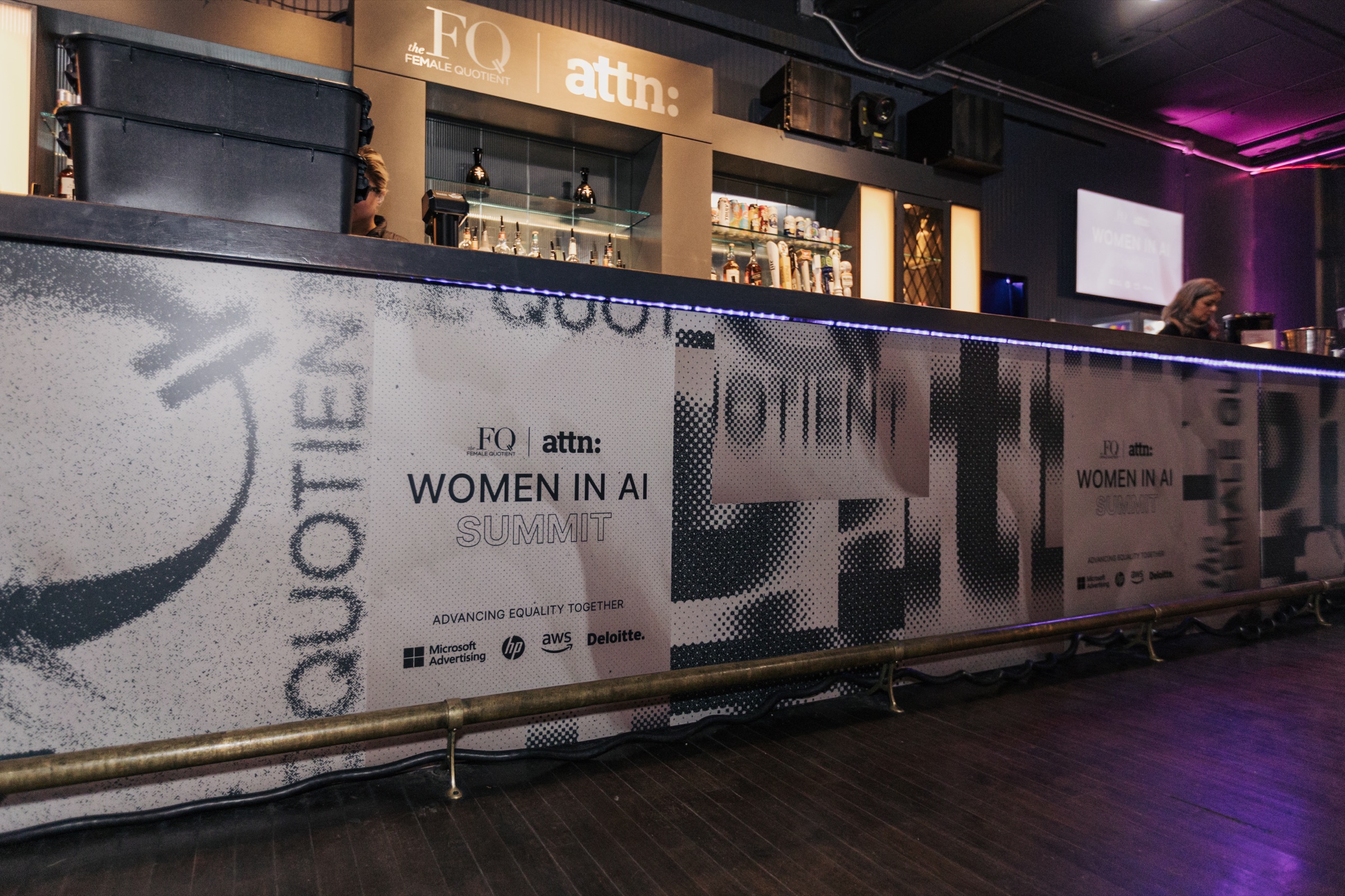 Reflective Women in AI Summit branding across the Webster Hall bar