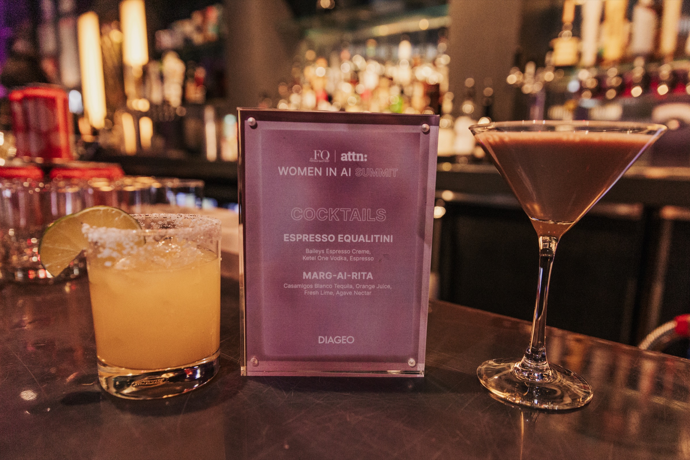 Women in AI Summit cocktail menu beside drinks at the bar