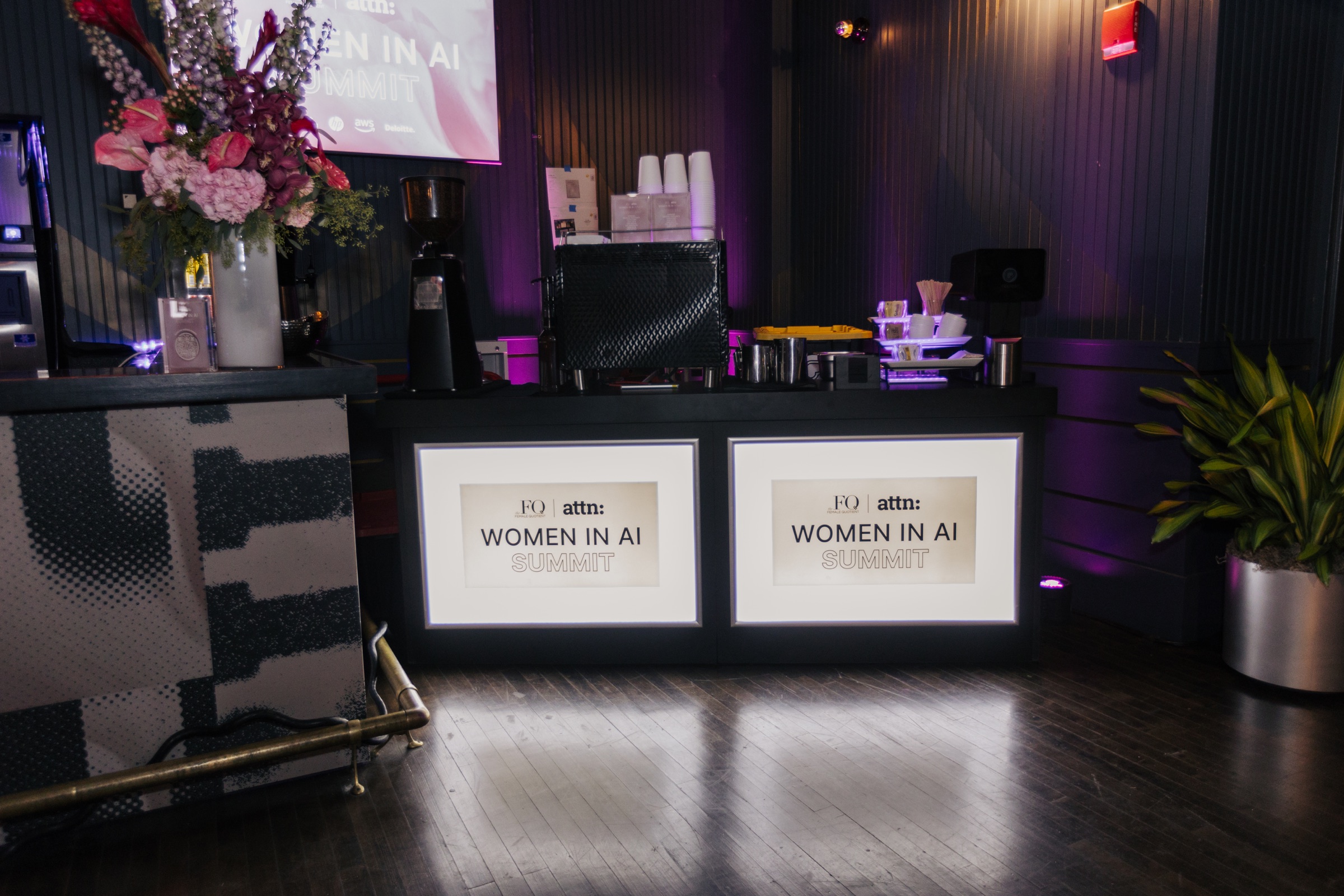 Women in AI Summit coffee station with floral styling and illuminated graphics