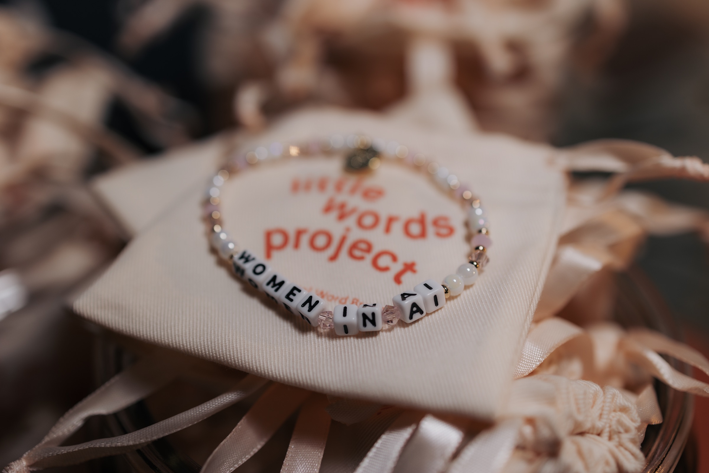 Words Project bracelet and Women in AI Summit tote detail