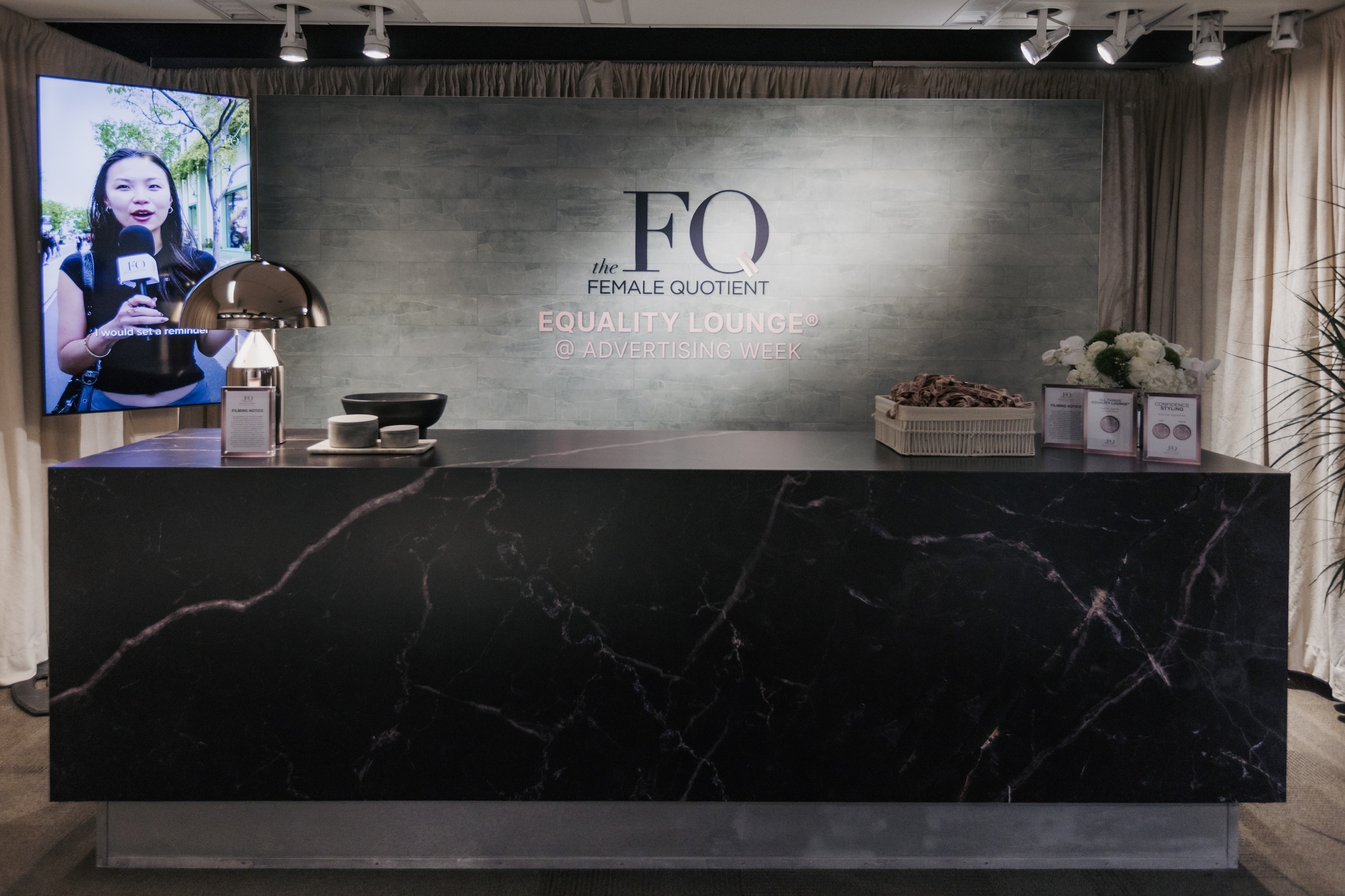 Branded Equality Lounge welcome wall and check-in counter