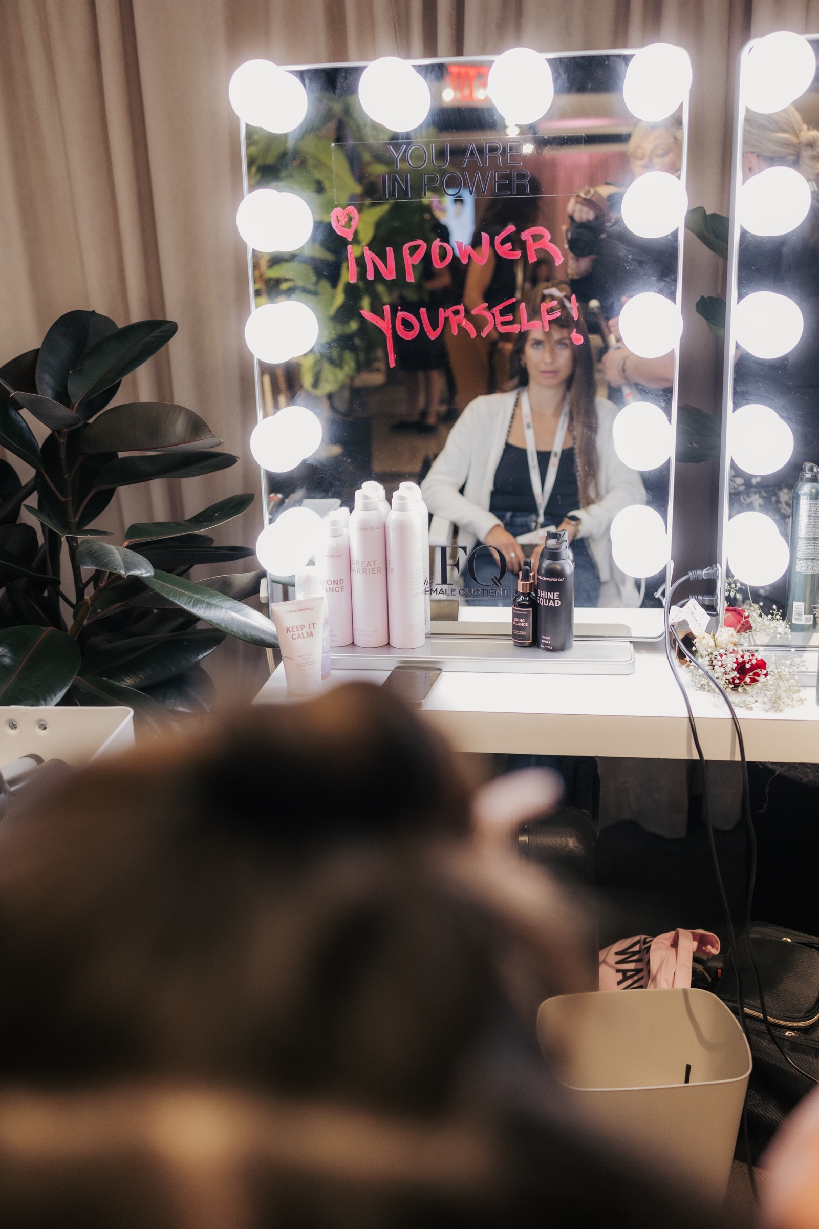 Guest reflected in an In Power Yourself confidence styling mirror