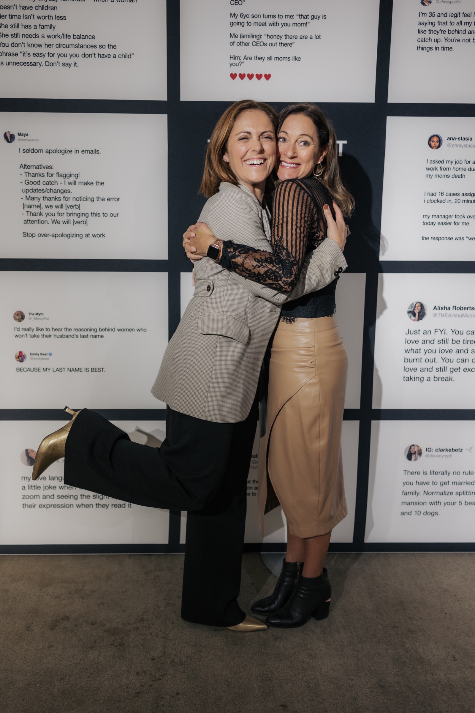 Two guests posing in front of the That’s What She Said social wall