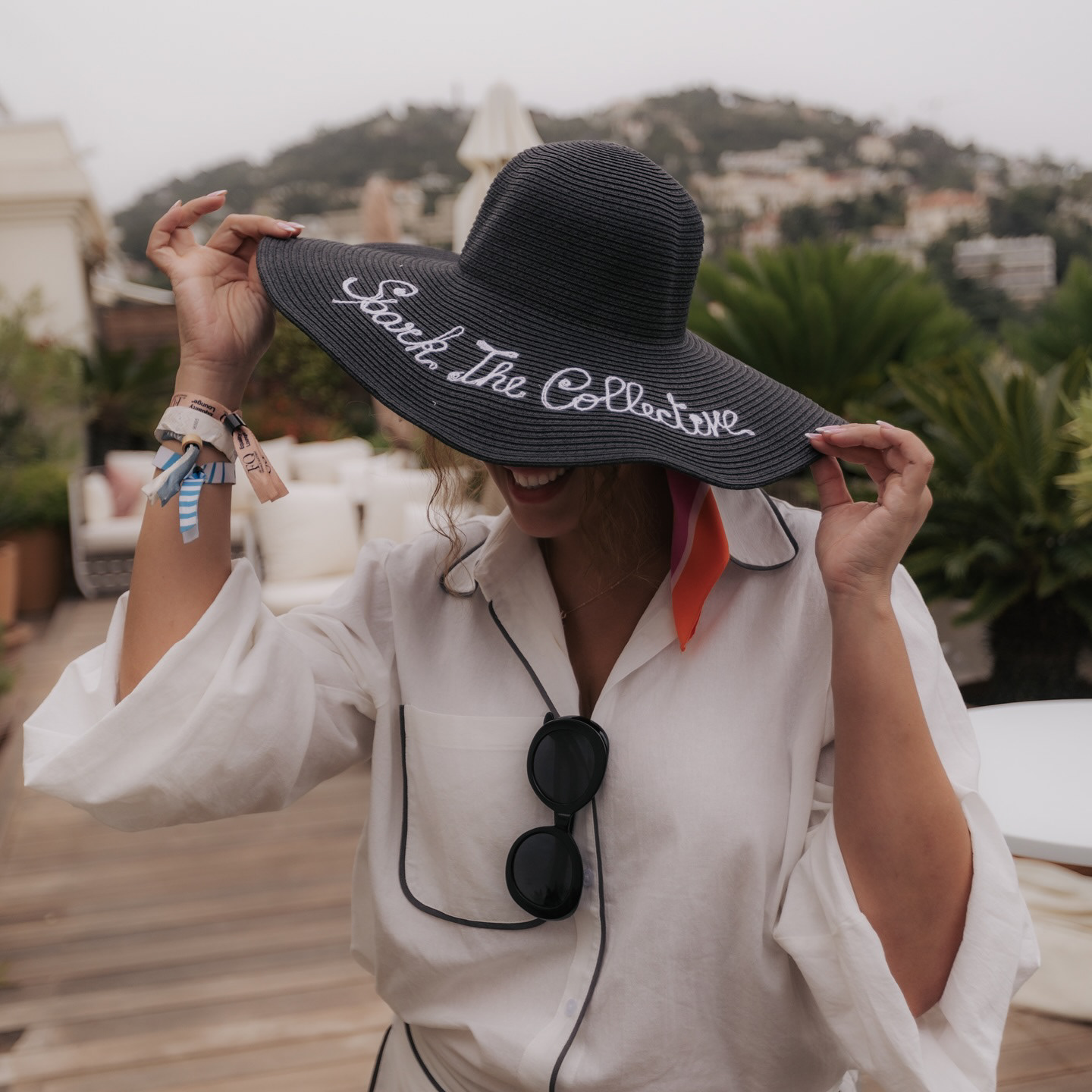 Guest showing a personalized Speak The Collective hat at the Equality Lounge