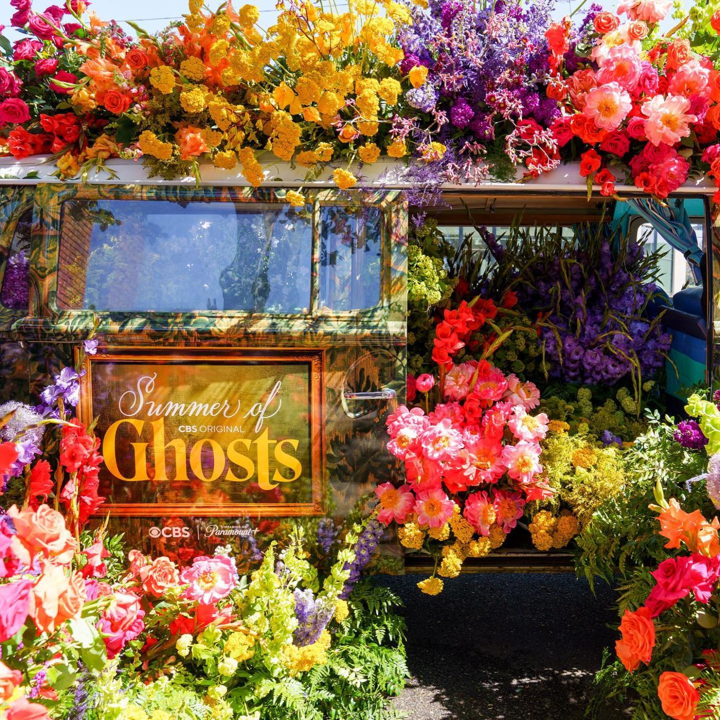 A flower-covered Summer of Ghosts bus created for the CBS campaign