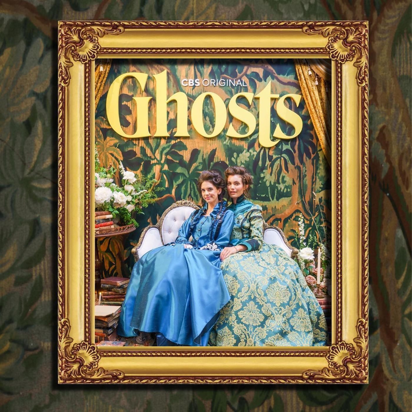 Gilded-frame Ghosts key art with two Victorian-dressed hosts on a settee