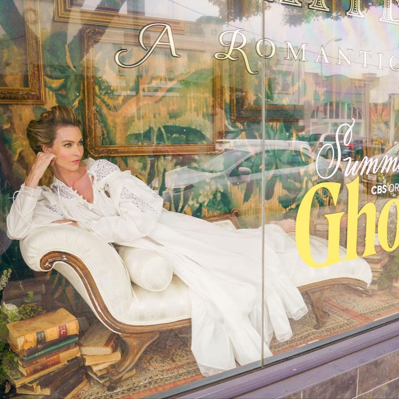 Bookstore window vignette with chaise lounge and Summer of Ghosts signage