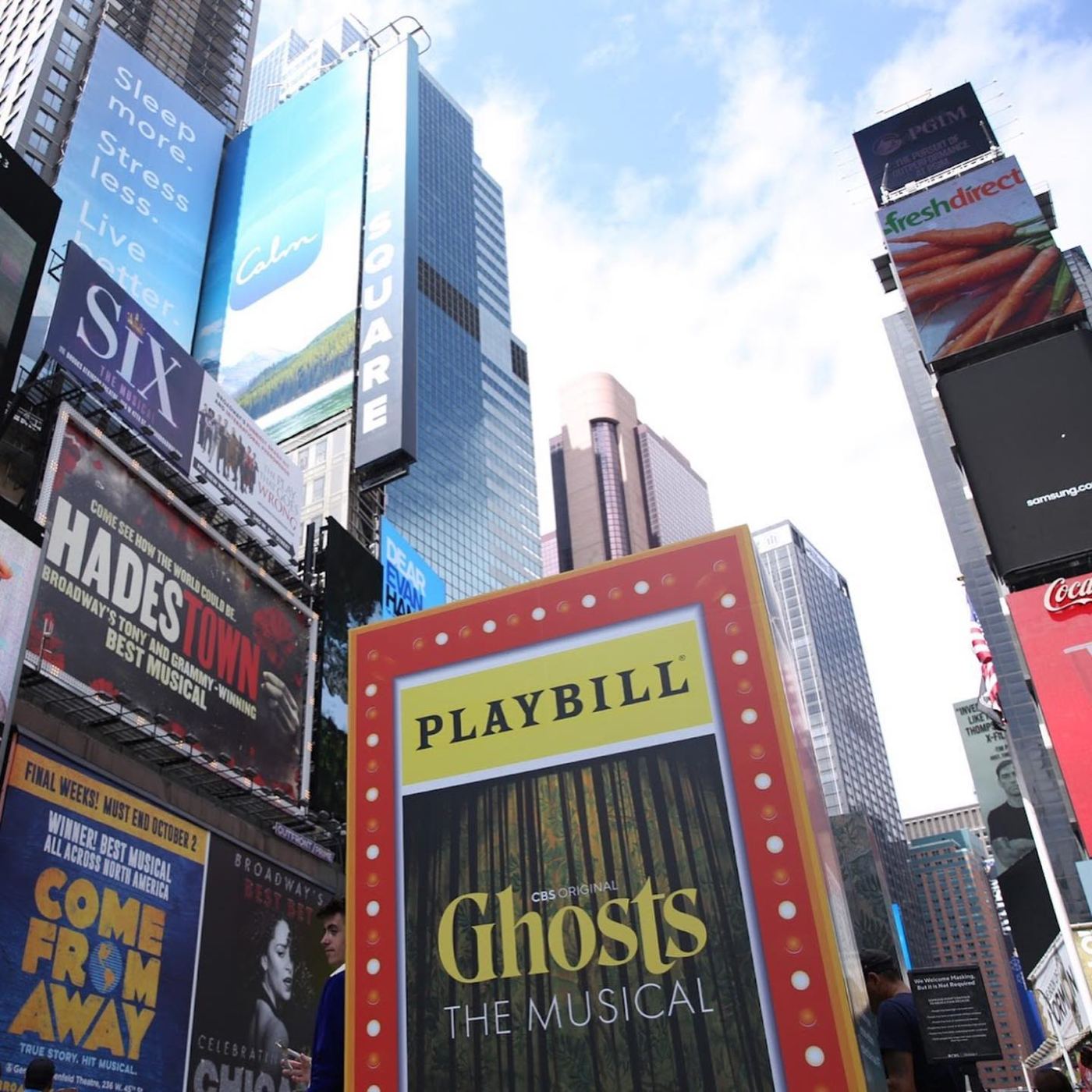 Playbill-framed Ghosts The Musical billboard rising over Times Square