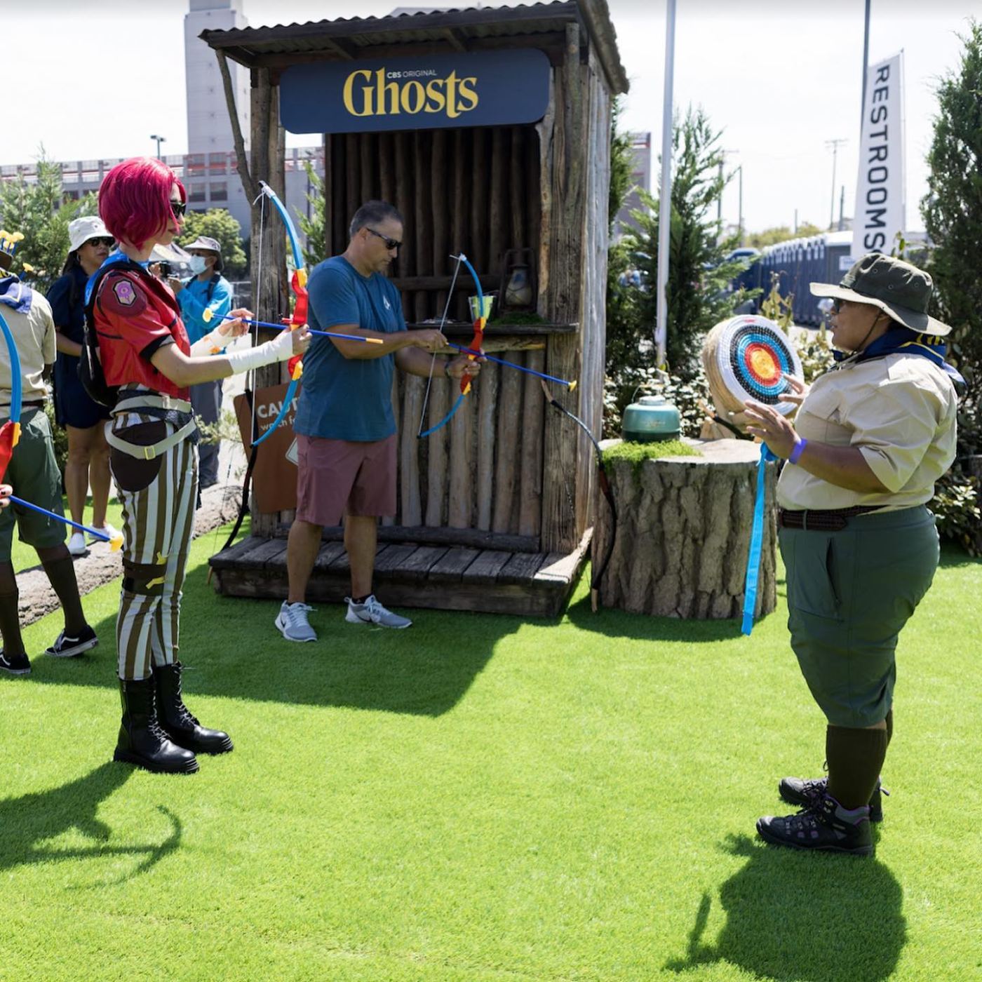 Fans at the archery range with a scout-uniformed brand ambassador