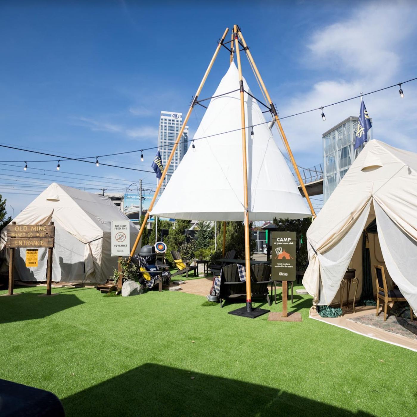 Glamping tents, Old Mine Shaft entrance and Do Not Feed The Psychics signage