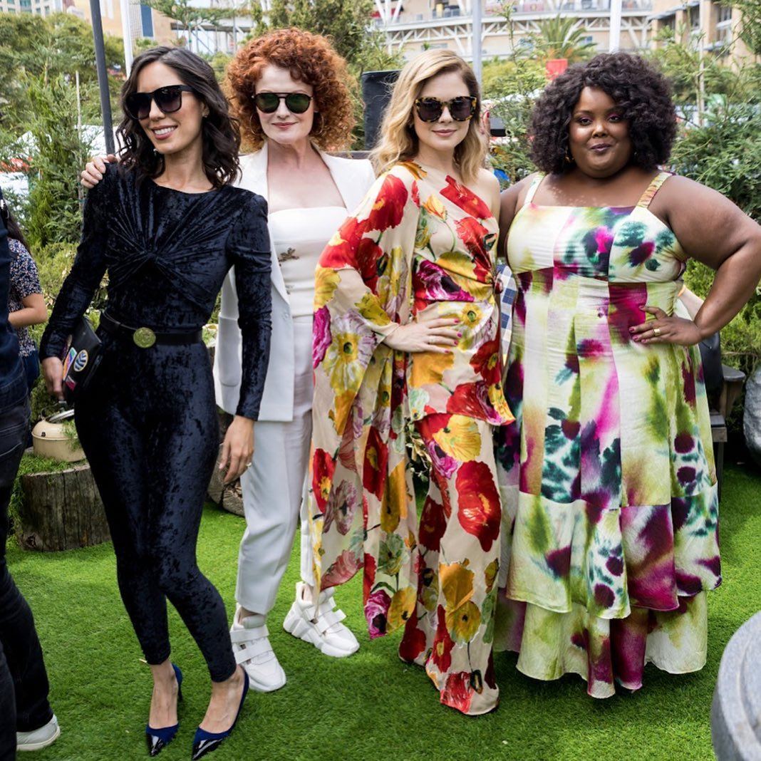 Cast members of Ghosts on the campground turf at Comic-Con