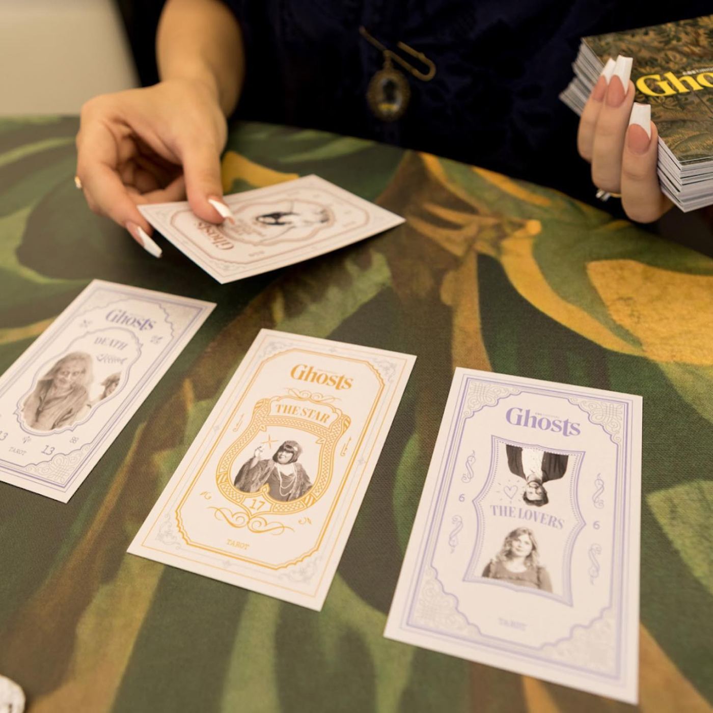 Ghosts character tarot cards being read at the psychic tent