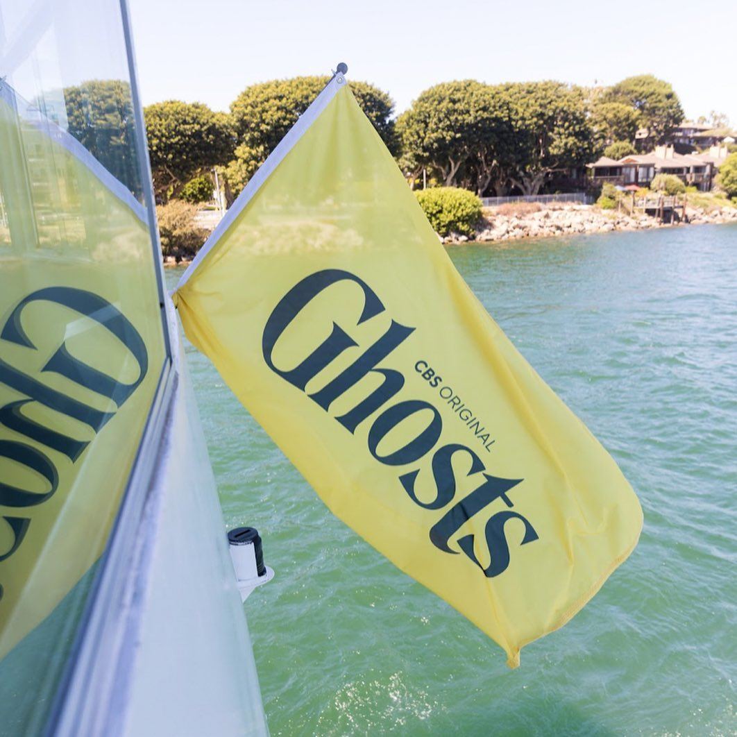 CBS Original Ghosts flag flying from the yacht over the marina