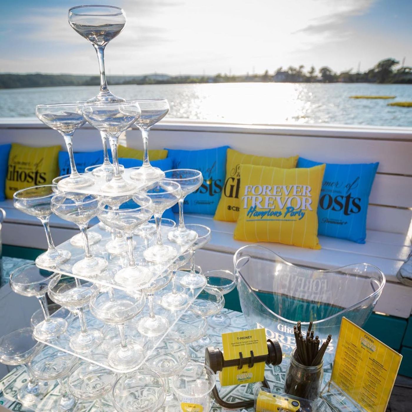 Champagne tower and branded pillows on the deck overlooking Fort Pond
