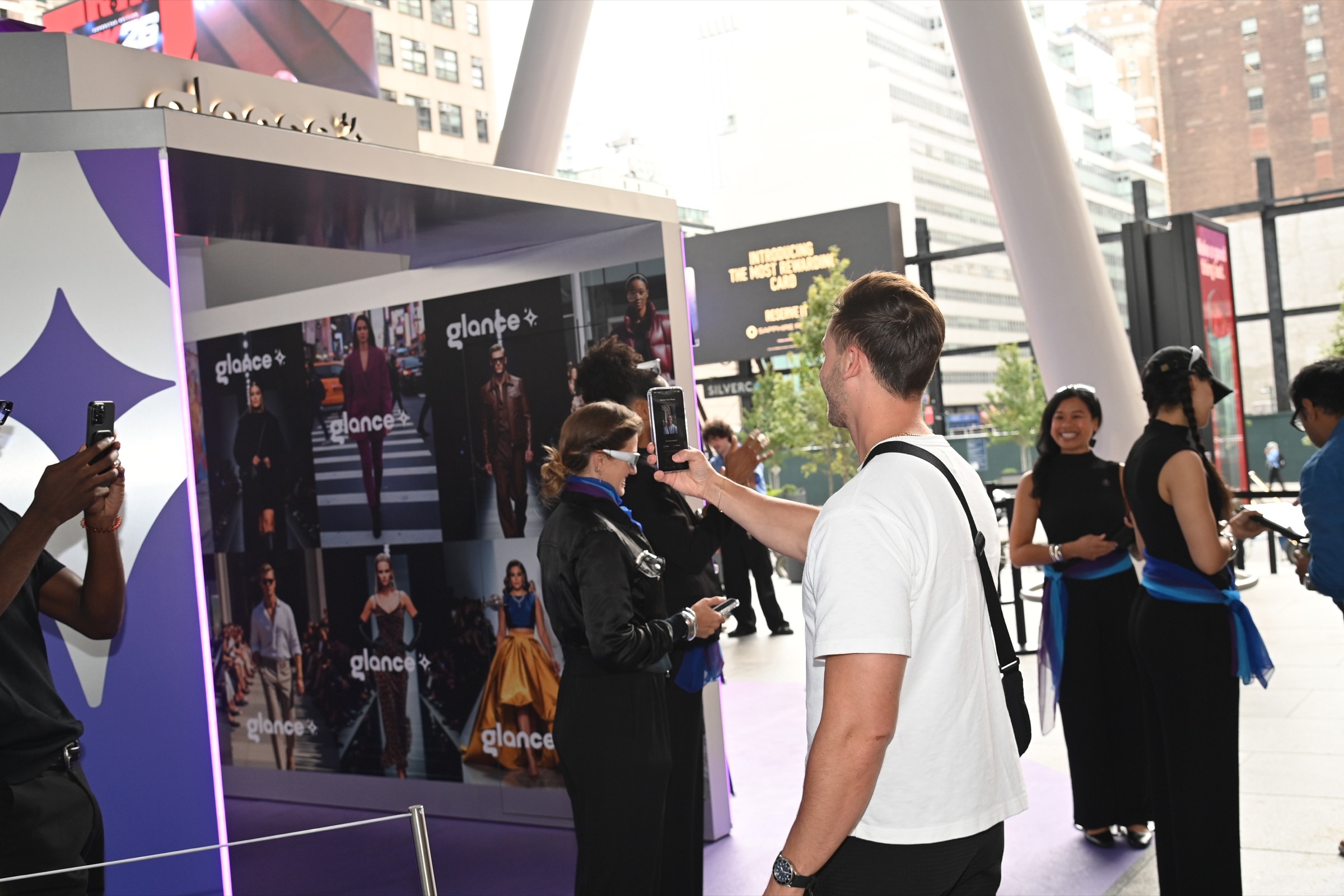 A guest using the Glance AI experience at the newsstand