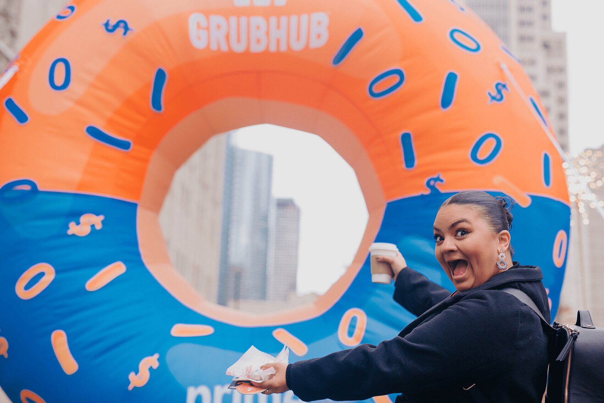 Guest reaching through the giant inflatable donut for a treat