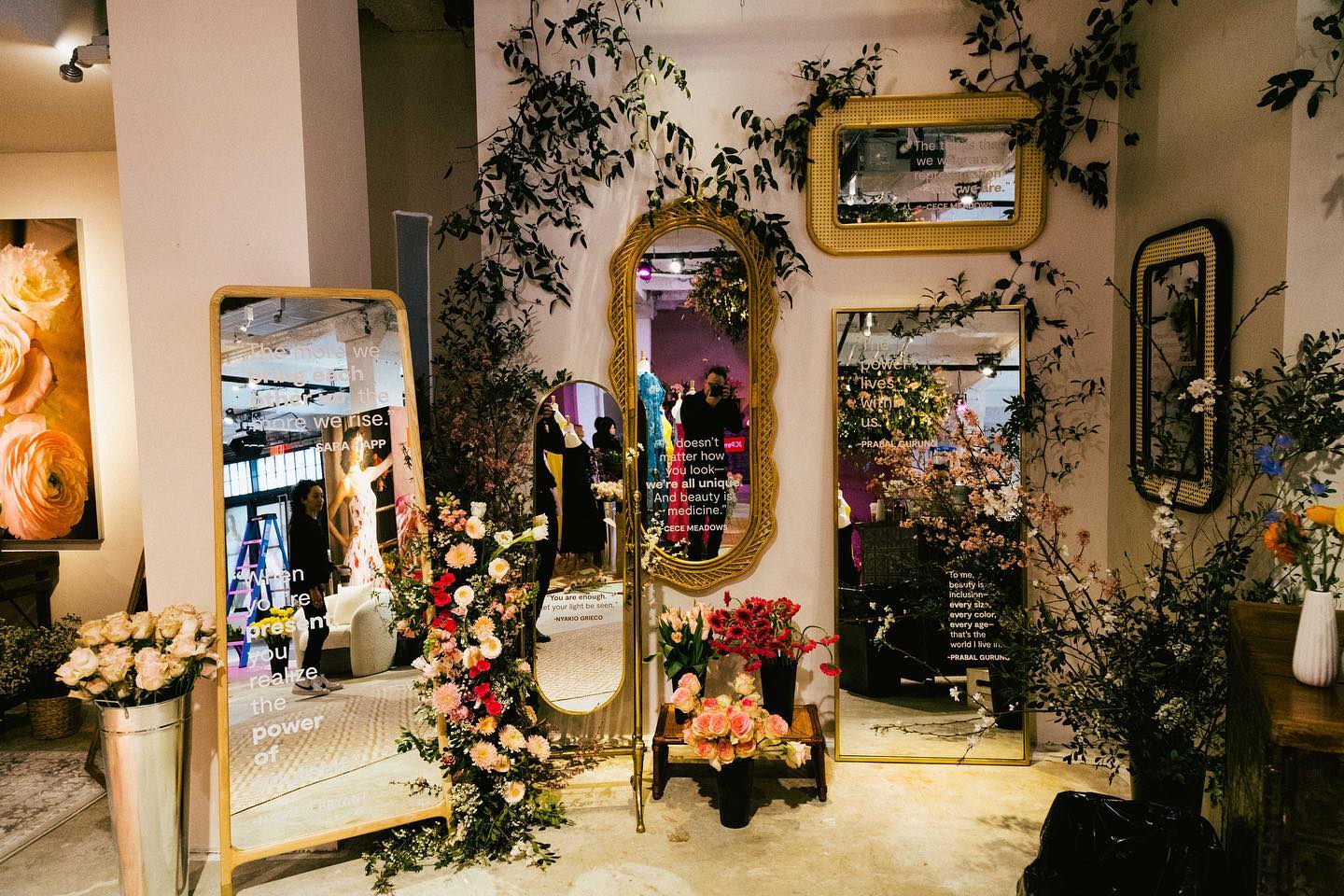 Layered mirrors, floral arrangements and campaign quotations inside Project Bloom