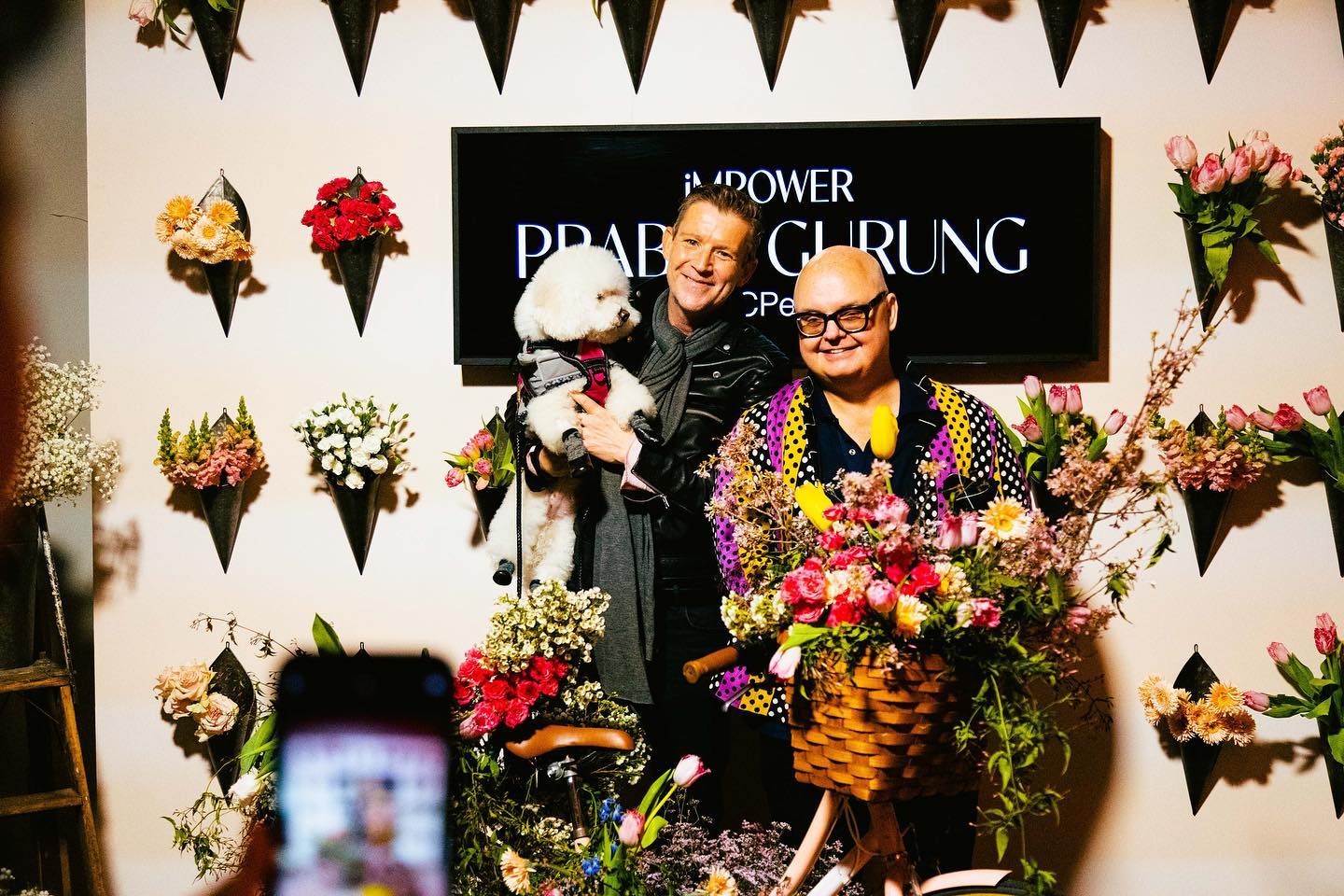 Guests posing at the iMPOWER Prabal Gurung floral photo moment