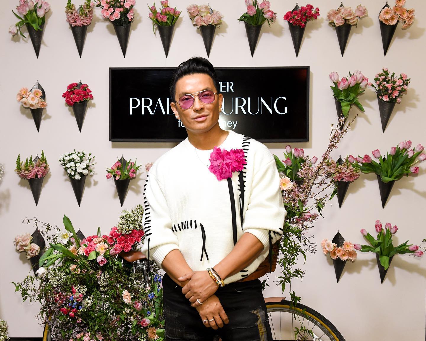 Prabal Gurung portrait in front of the flower-wall photo moment