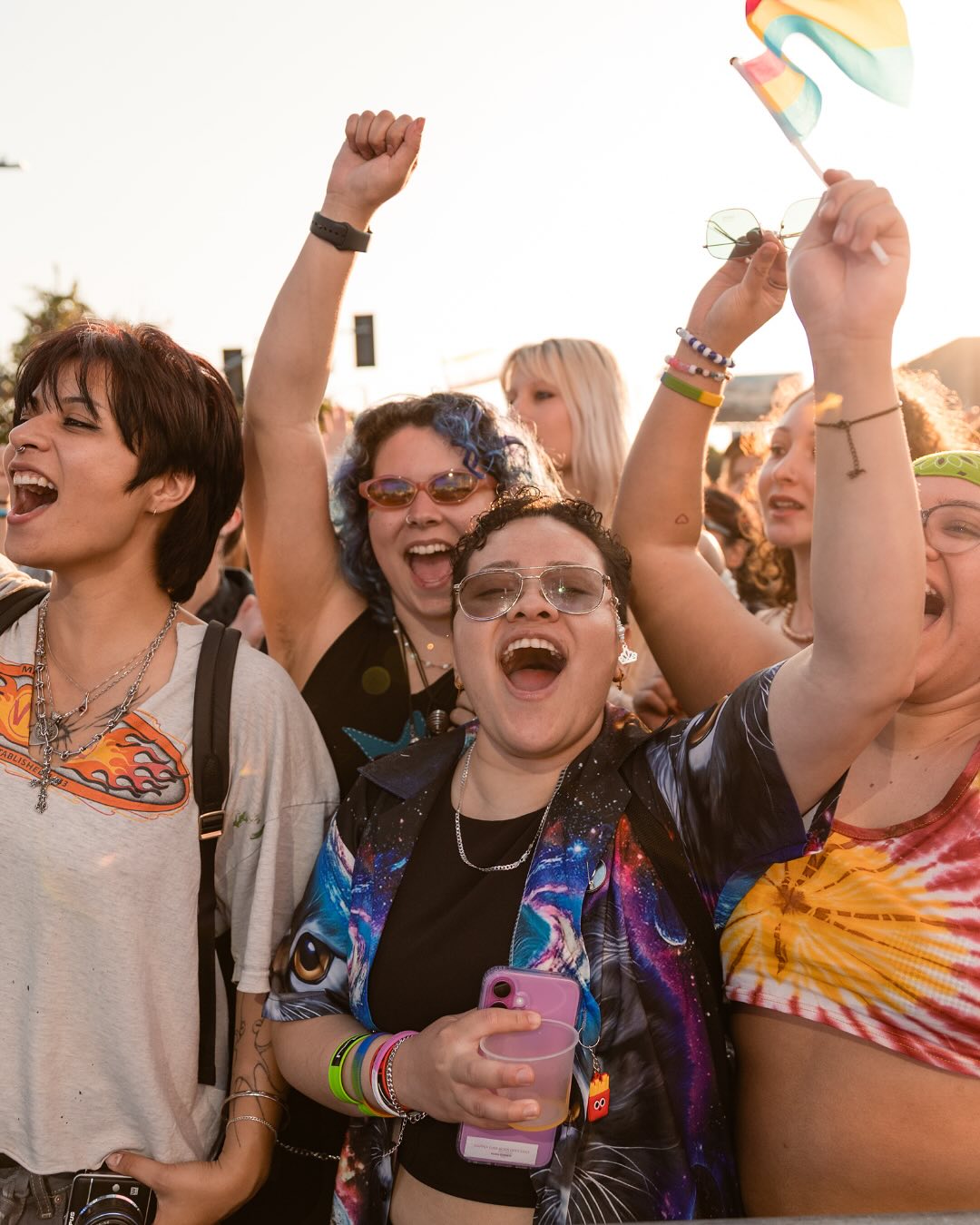 Crowd cheering at golden hour