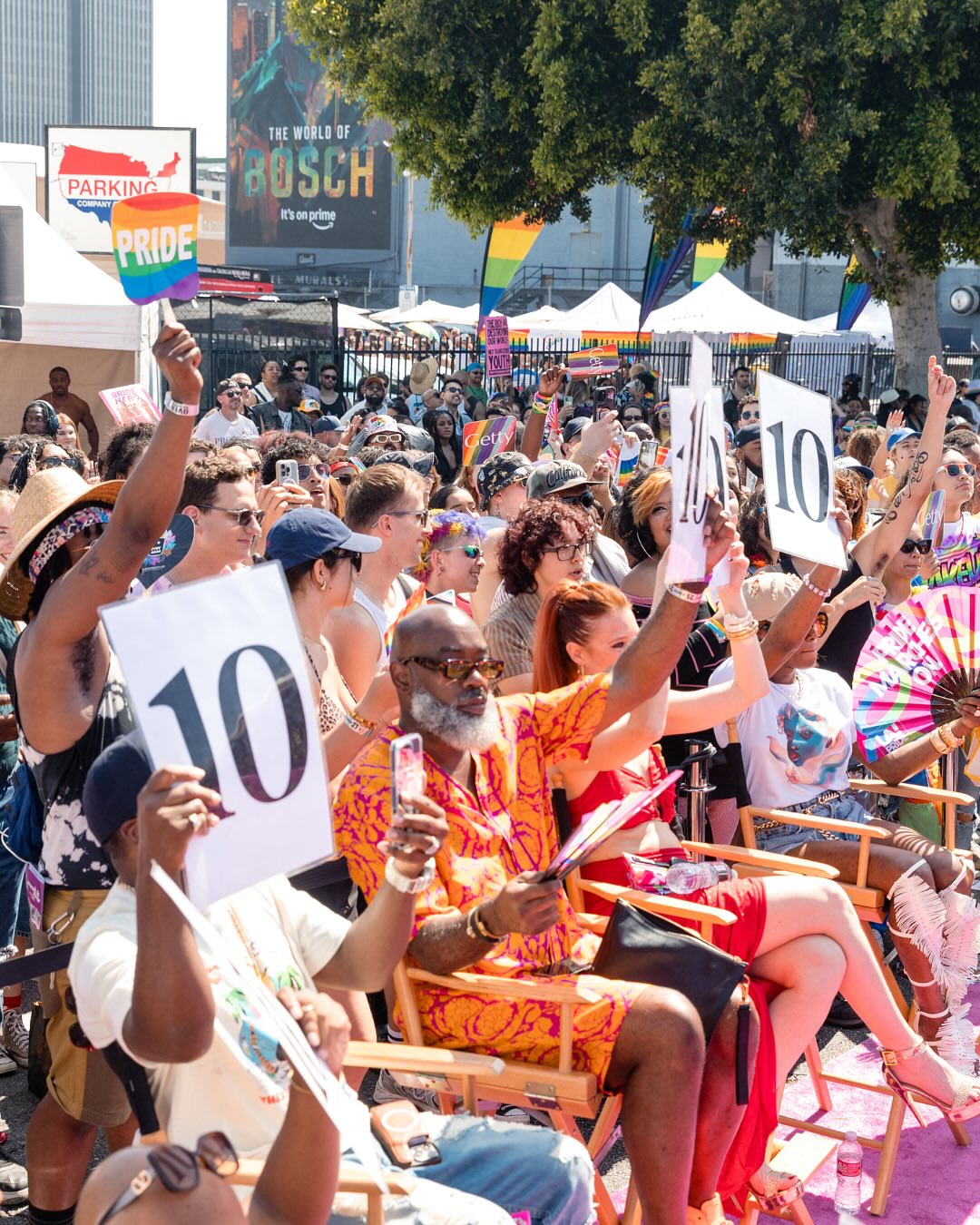 Judges' row holding up 10s at the Community Stage