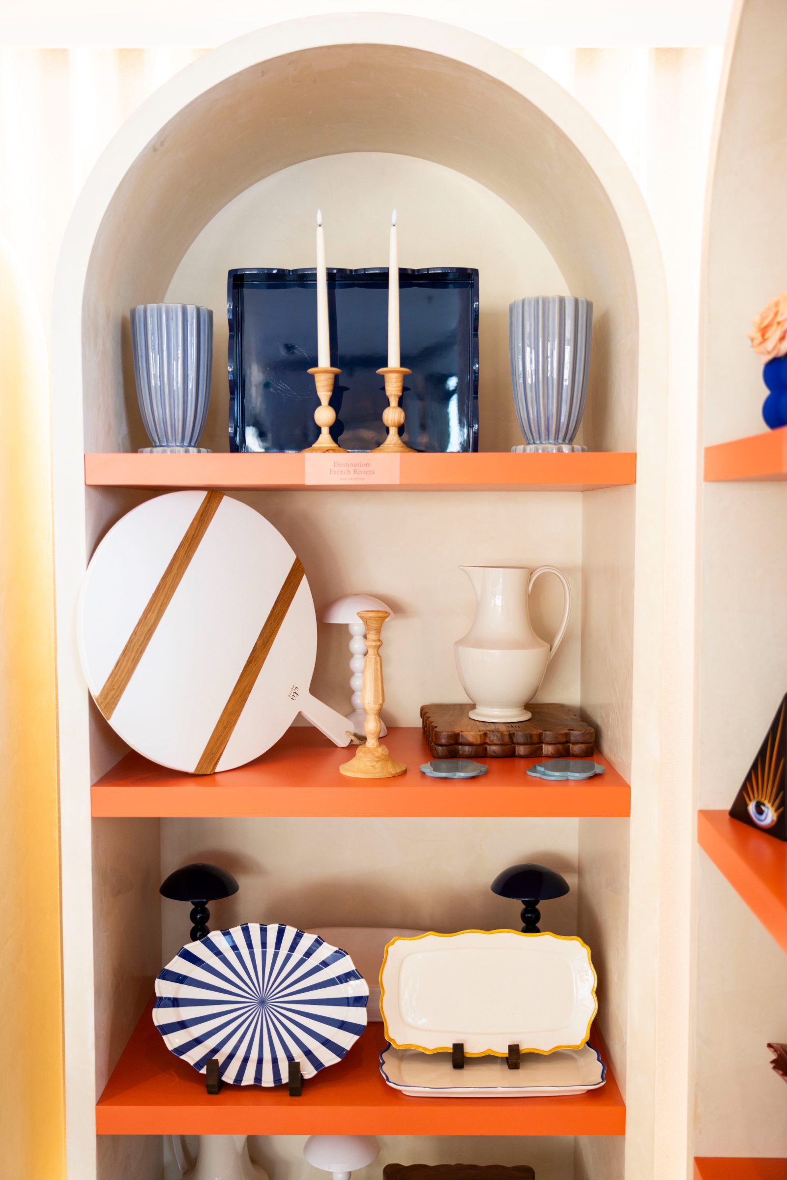 Destination French Riviera shelf styled with tableware and candlesticks
