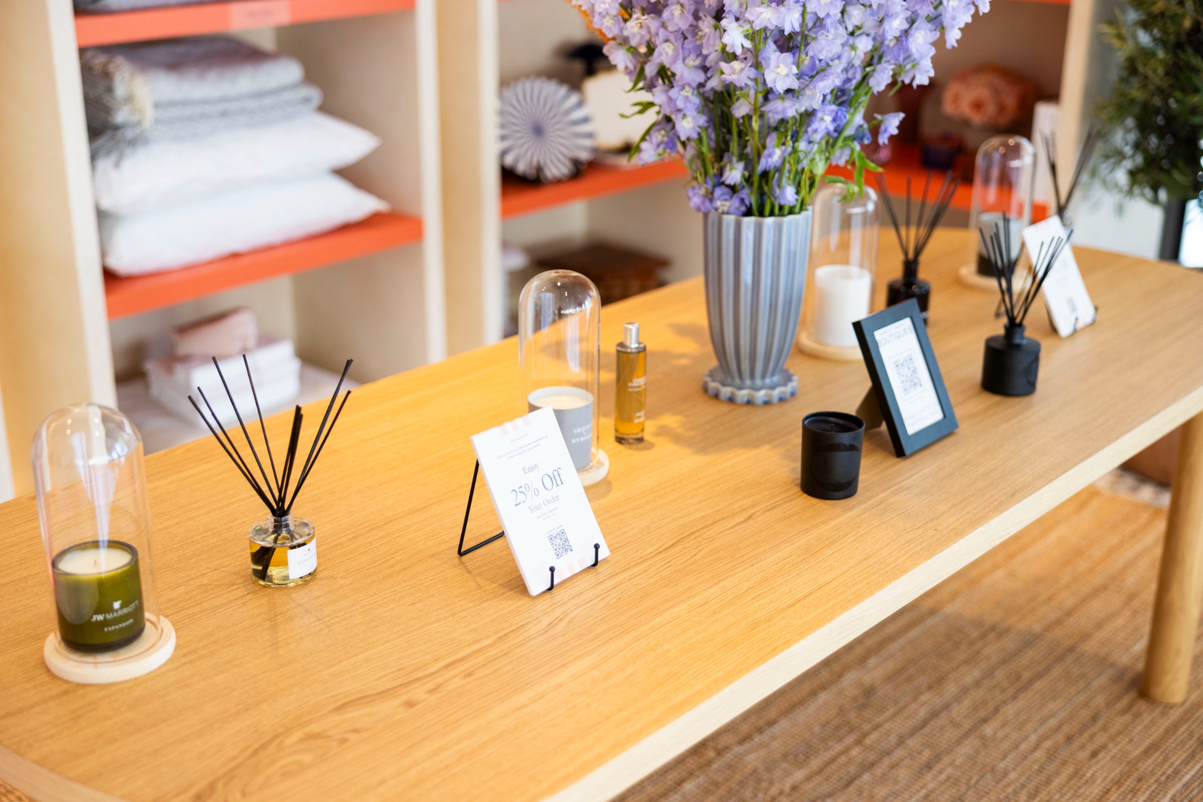 Fragrance table with diffusers, candles and the 25 percent off card