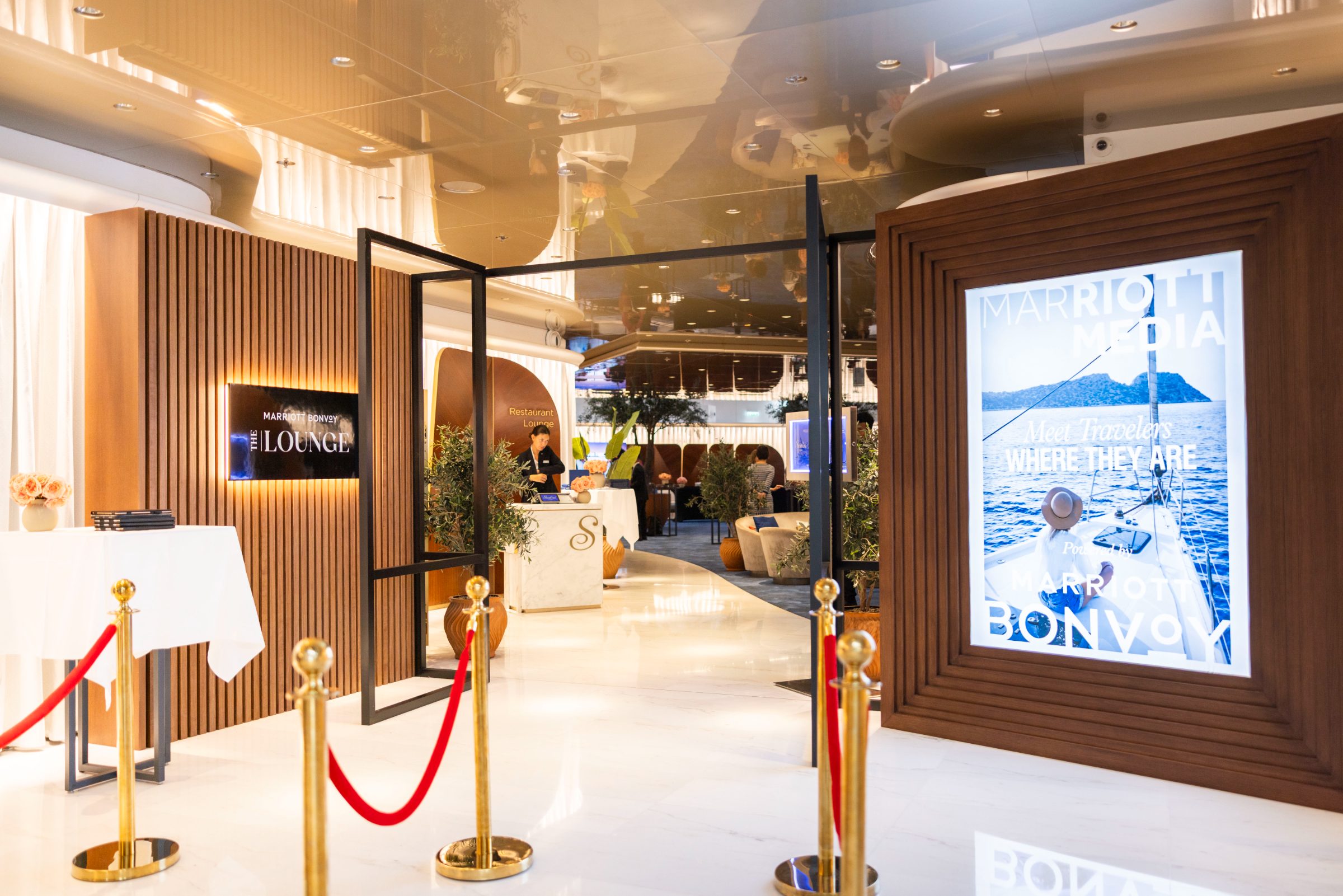 The Lounge entrance with red velvet ropes and a Marriott Media lightbox