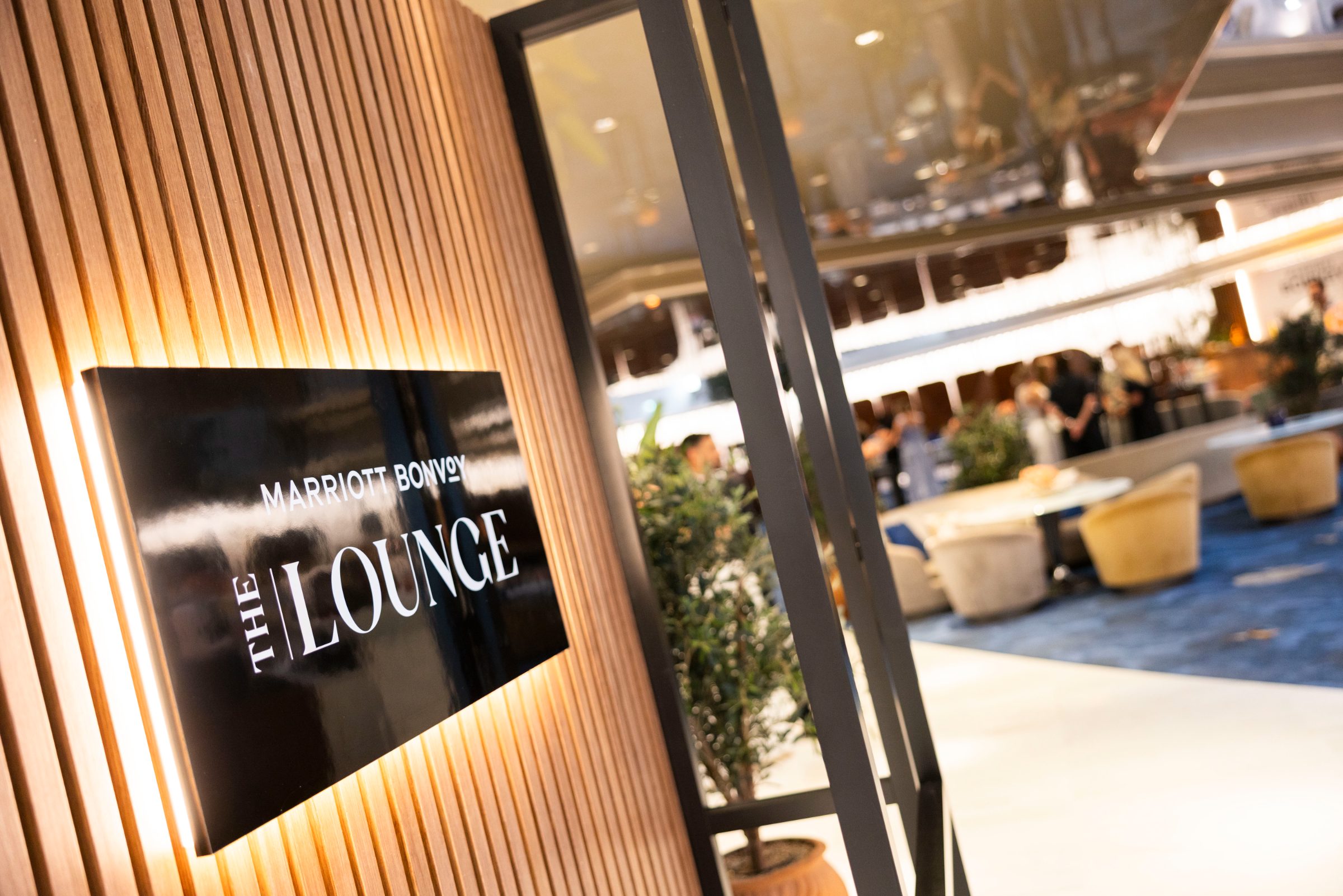 Backlit Marriott Bonvoy The Lounge sign on slatted wood