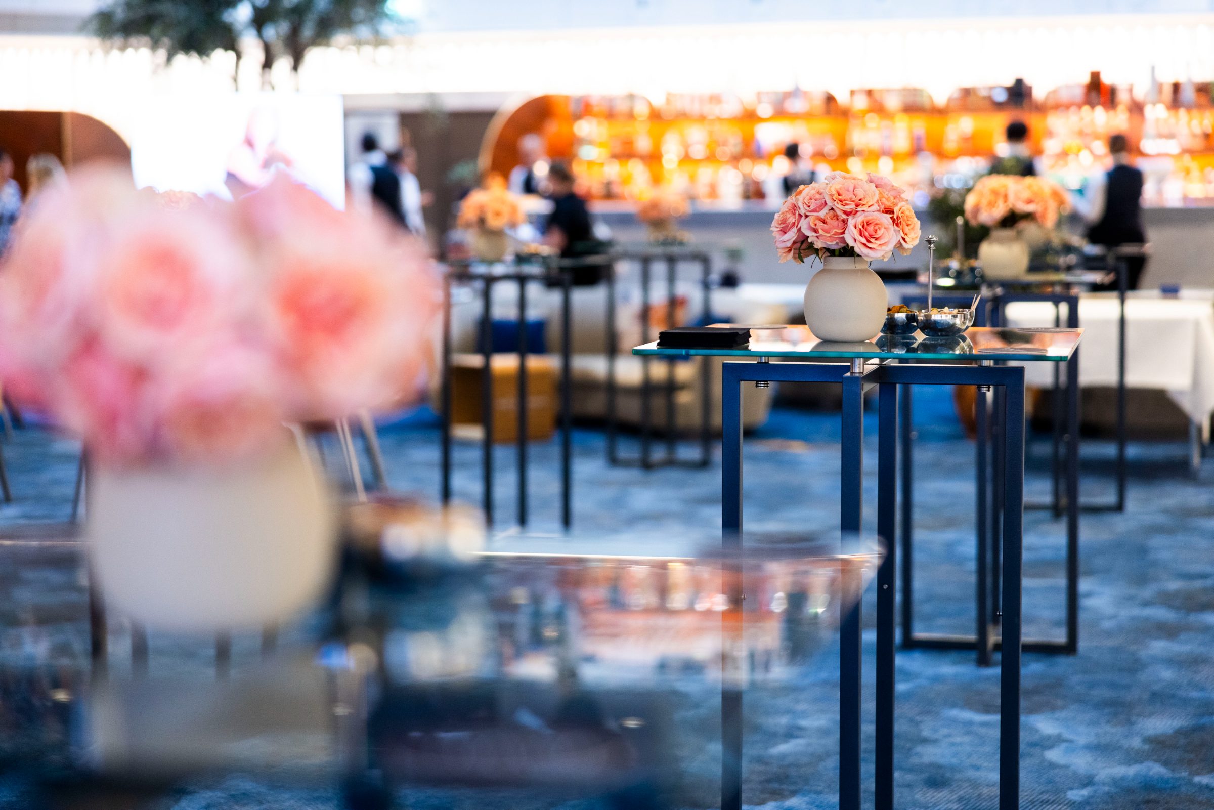 Rose-topped cocktail tables across The Lounge floor