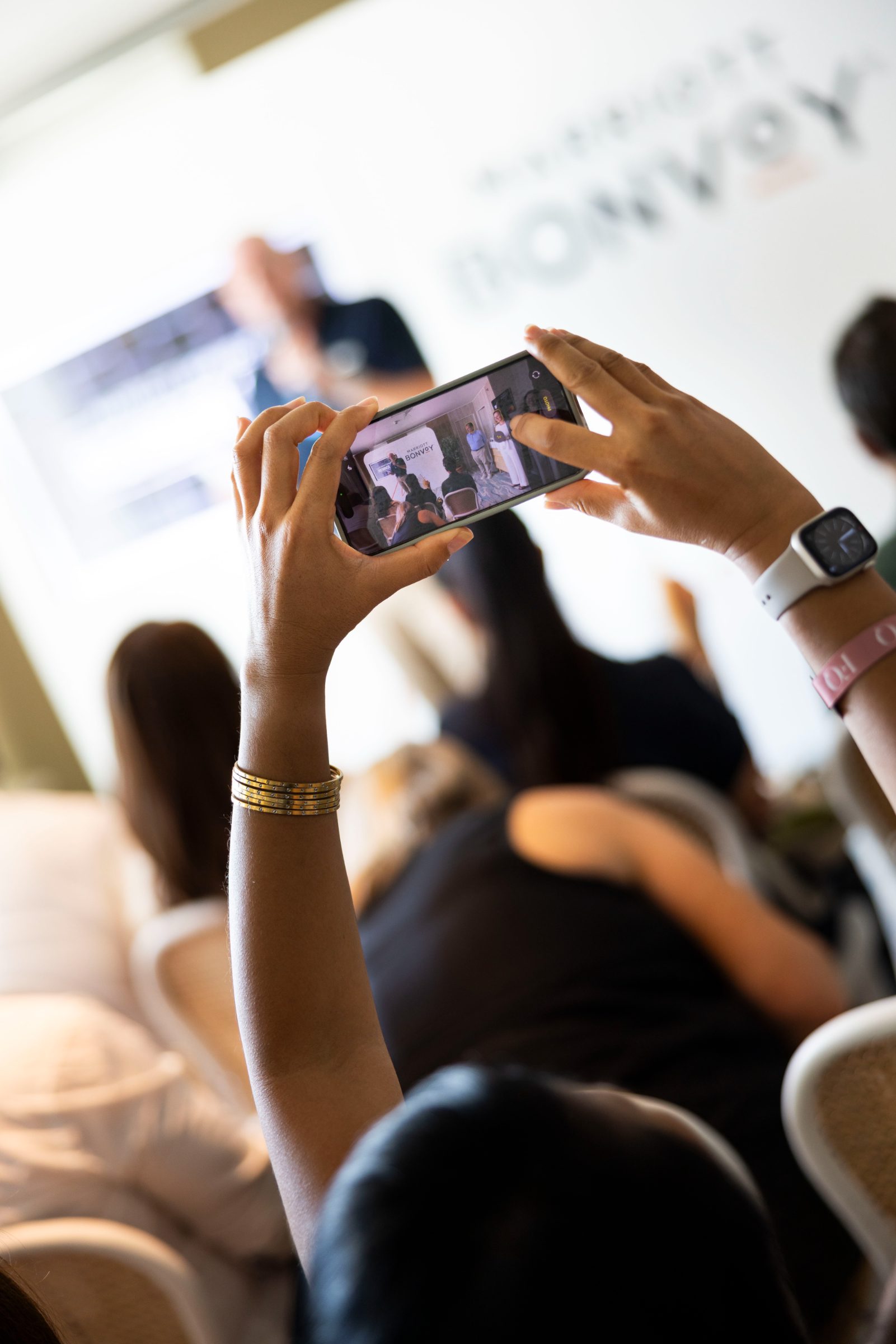 A member photographing the Member Day talk on their phone