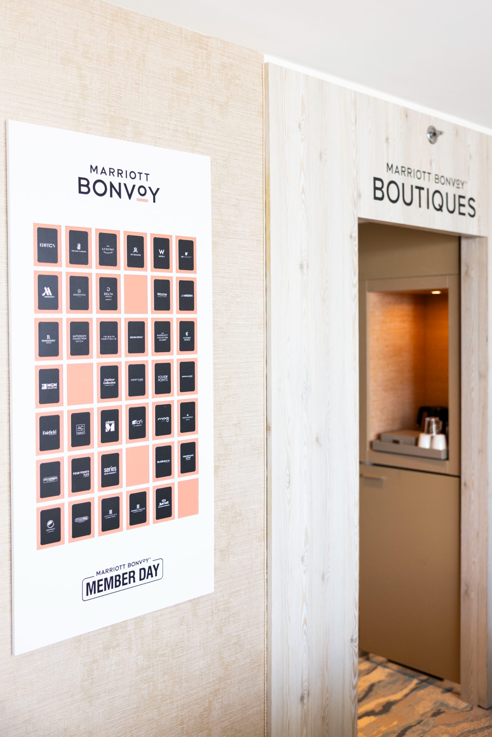 Member Day brand-portfolio poster beside the Bonvoy Boutiques doorway