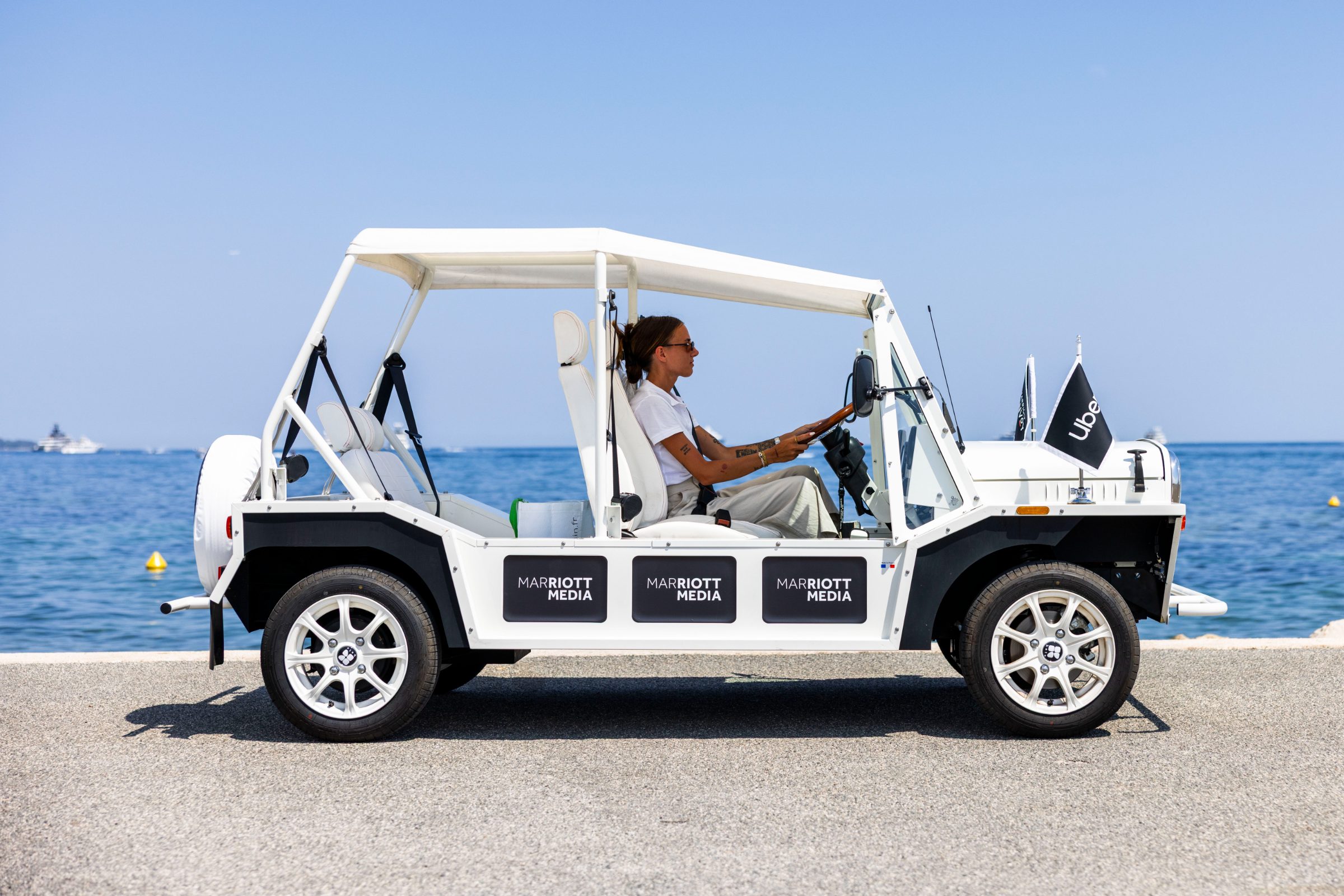 A Marriott-branded Moke traveling the Cannes coastline