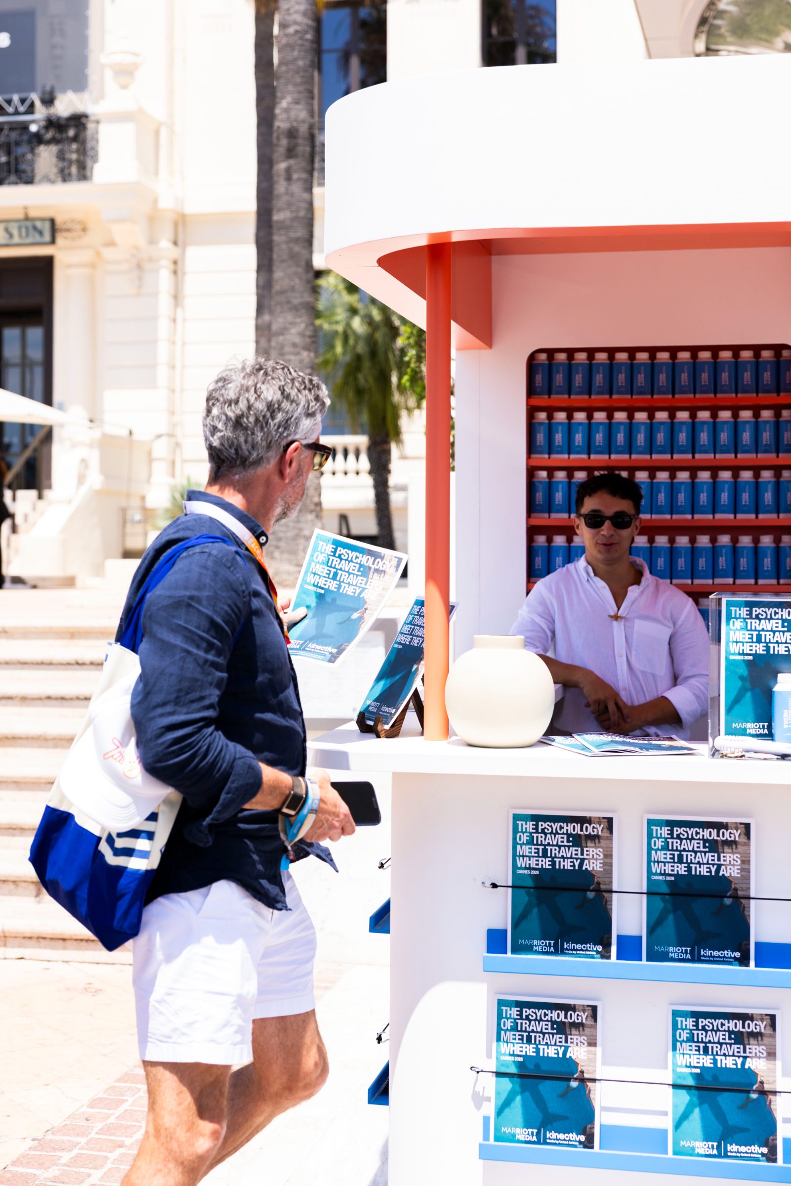 A guest browsing printed Traveler Reports at the Marriott Media newsstand