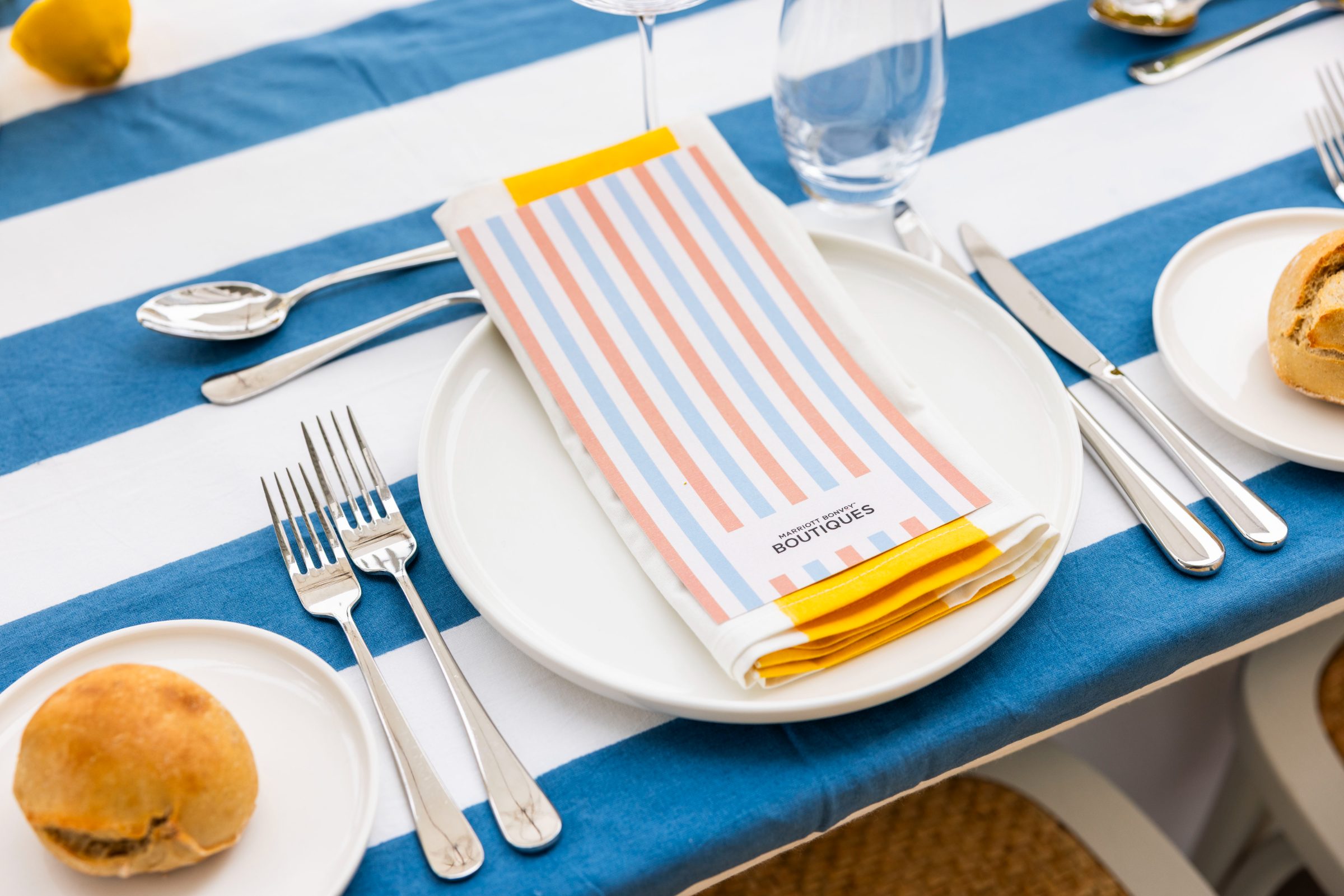 Custom striped menu and place setting at a Marriott Bonvoy lunch