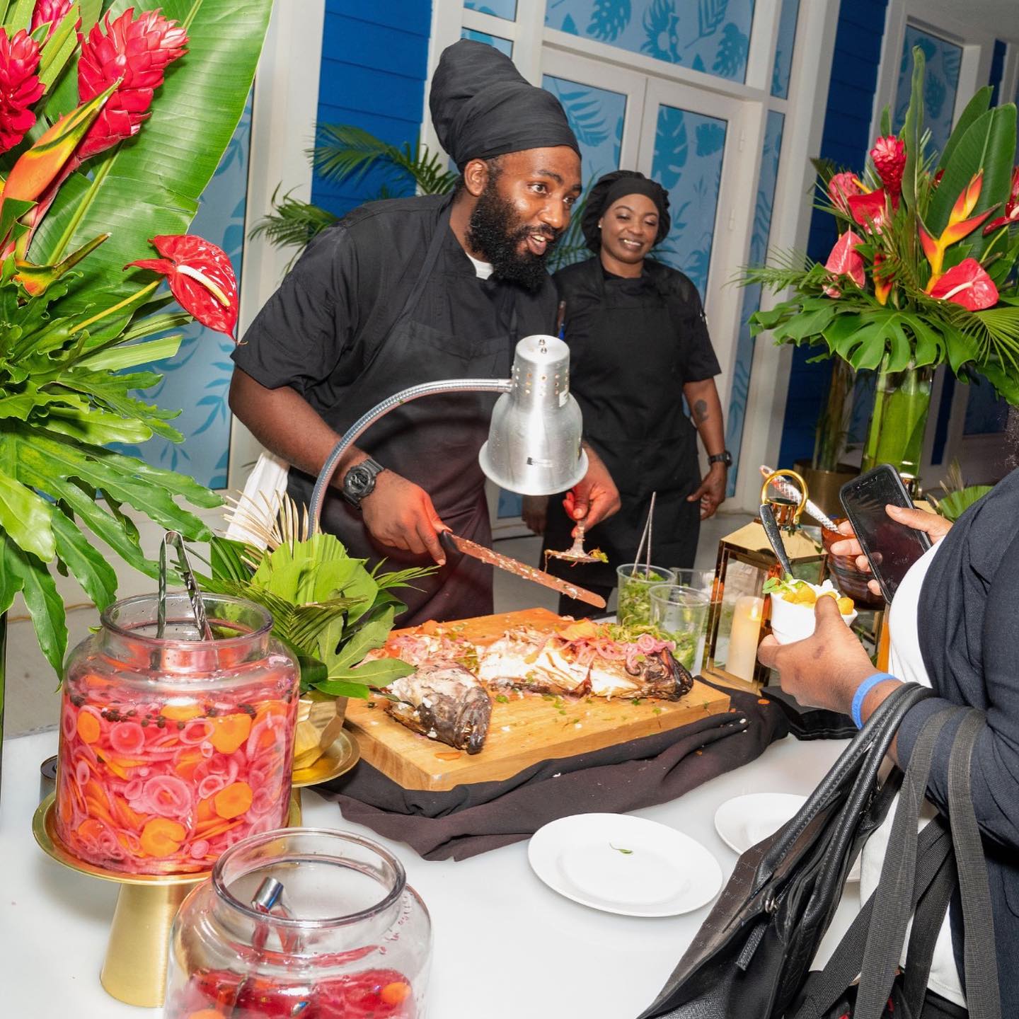 Bahamian chef serving local cuisine at the grand opening