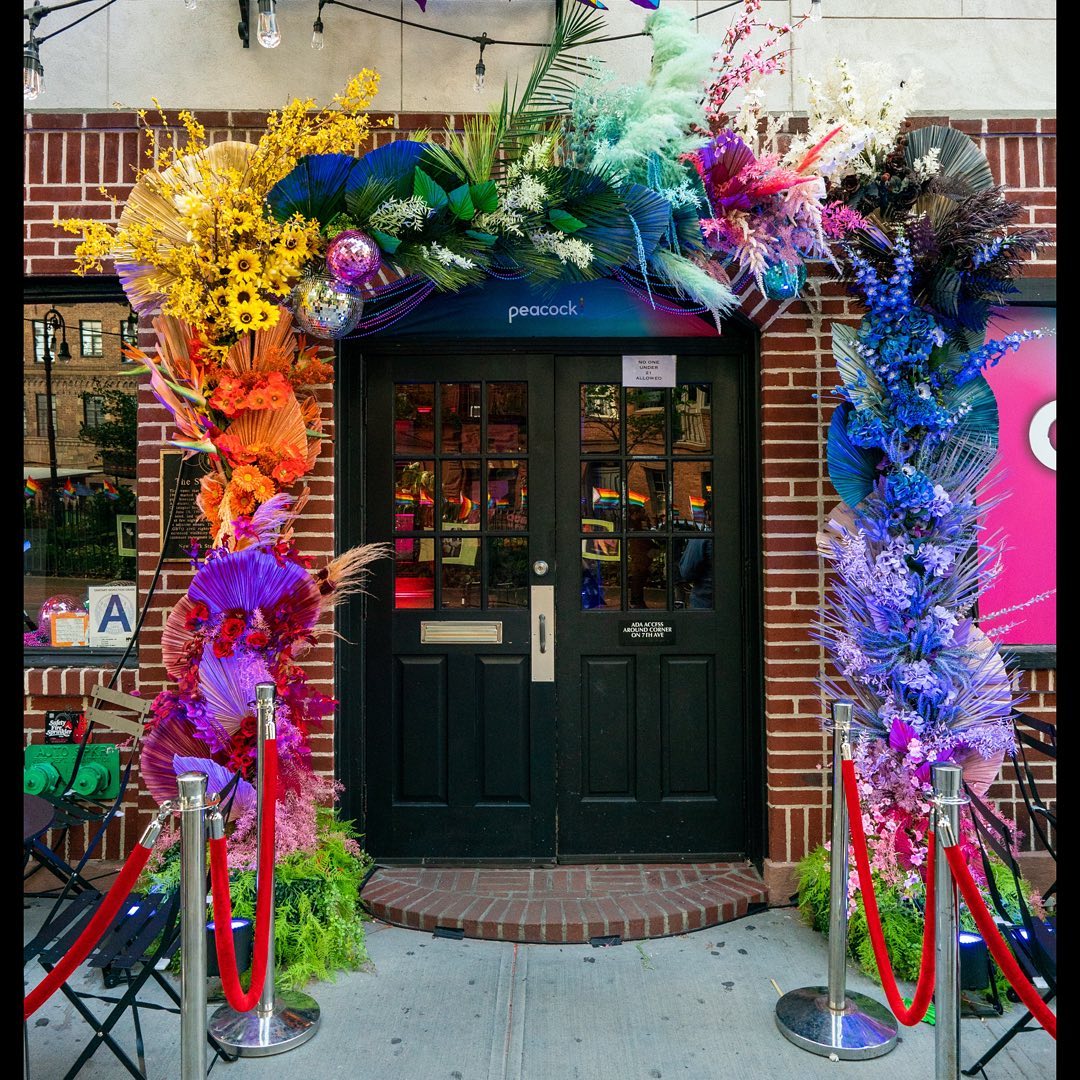 Colorful Peacock Queer As Folk floral entrance at The Stonewall Inn