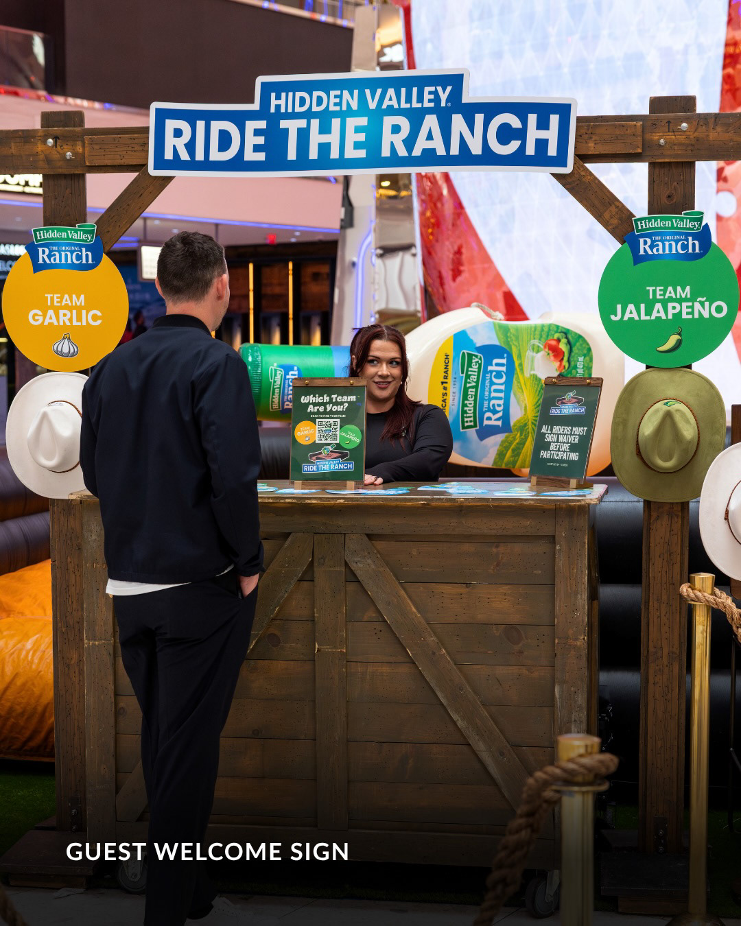 Ride The Ranch guest welcome station with Team Garlic and Team Jalapeño signage