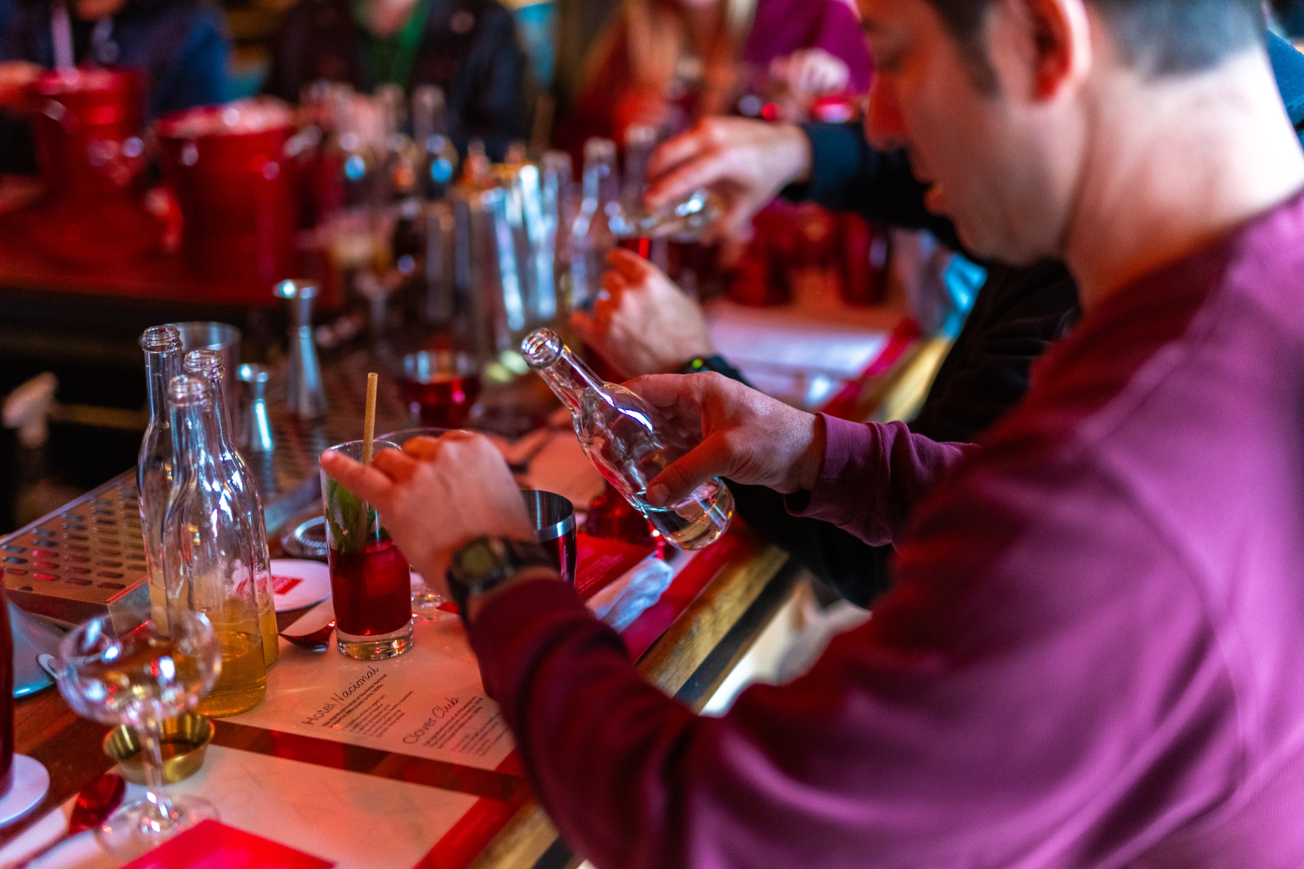 Guests mixing cocktails during a hands-on Autograph Journey class