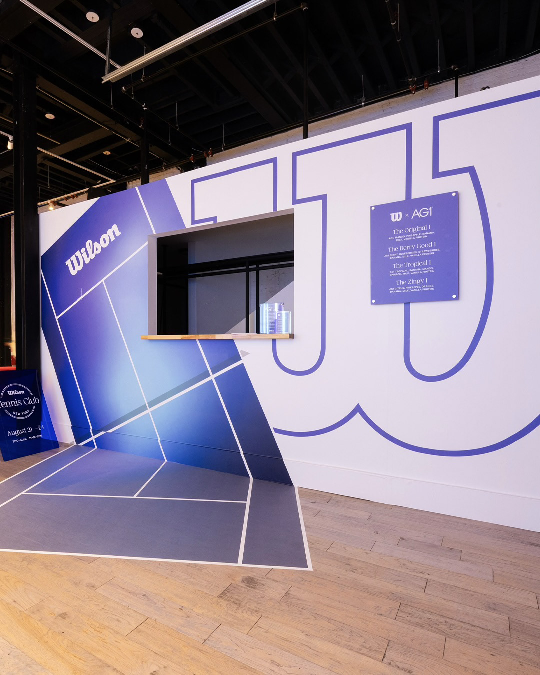 Wilson Tennis Club interior with oversized court graphics and wayfinding