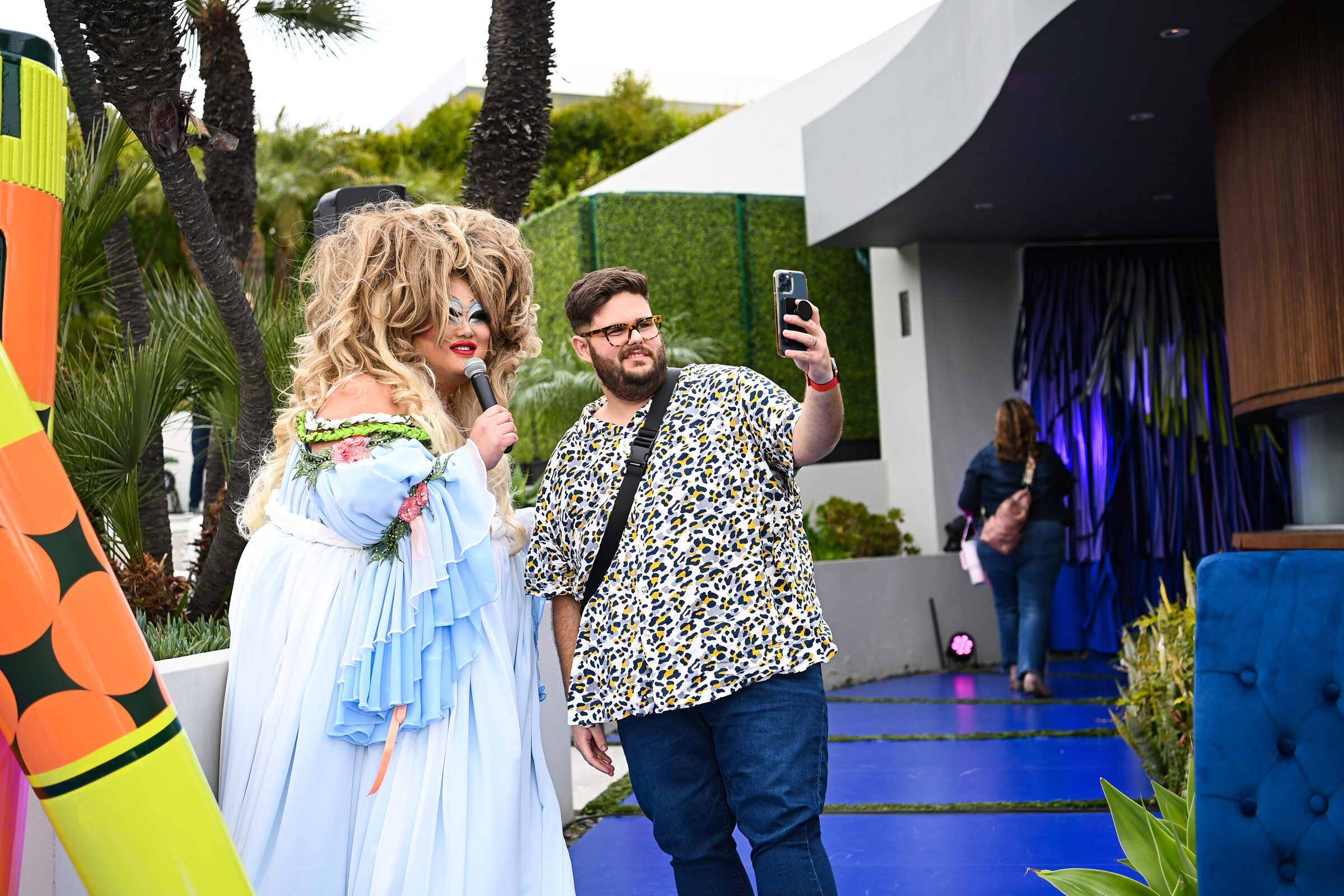 The MC filming a welcome moment with a guest on the blurple carpet