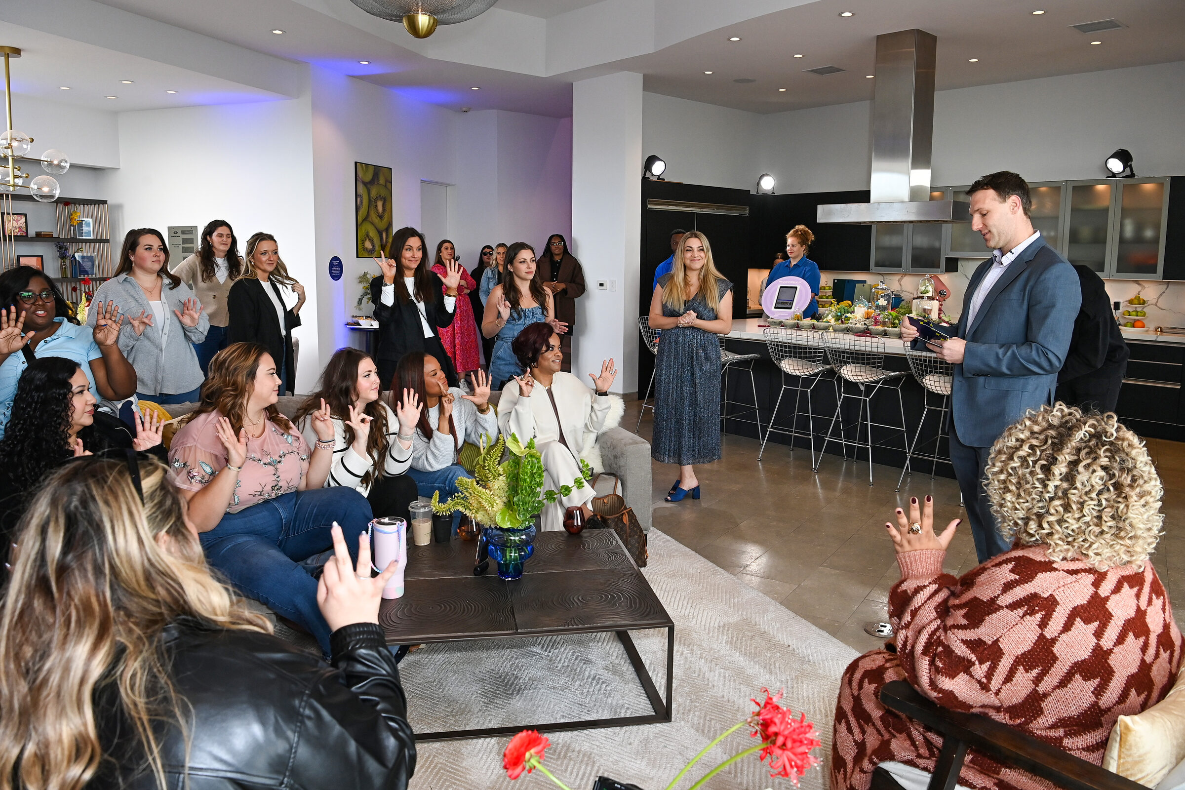 Guests laughing together in the living room during the welcome moment
