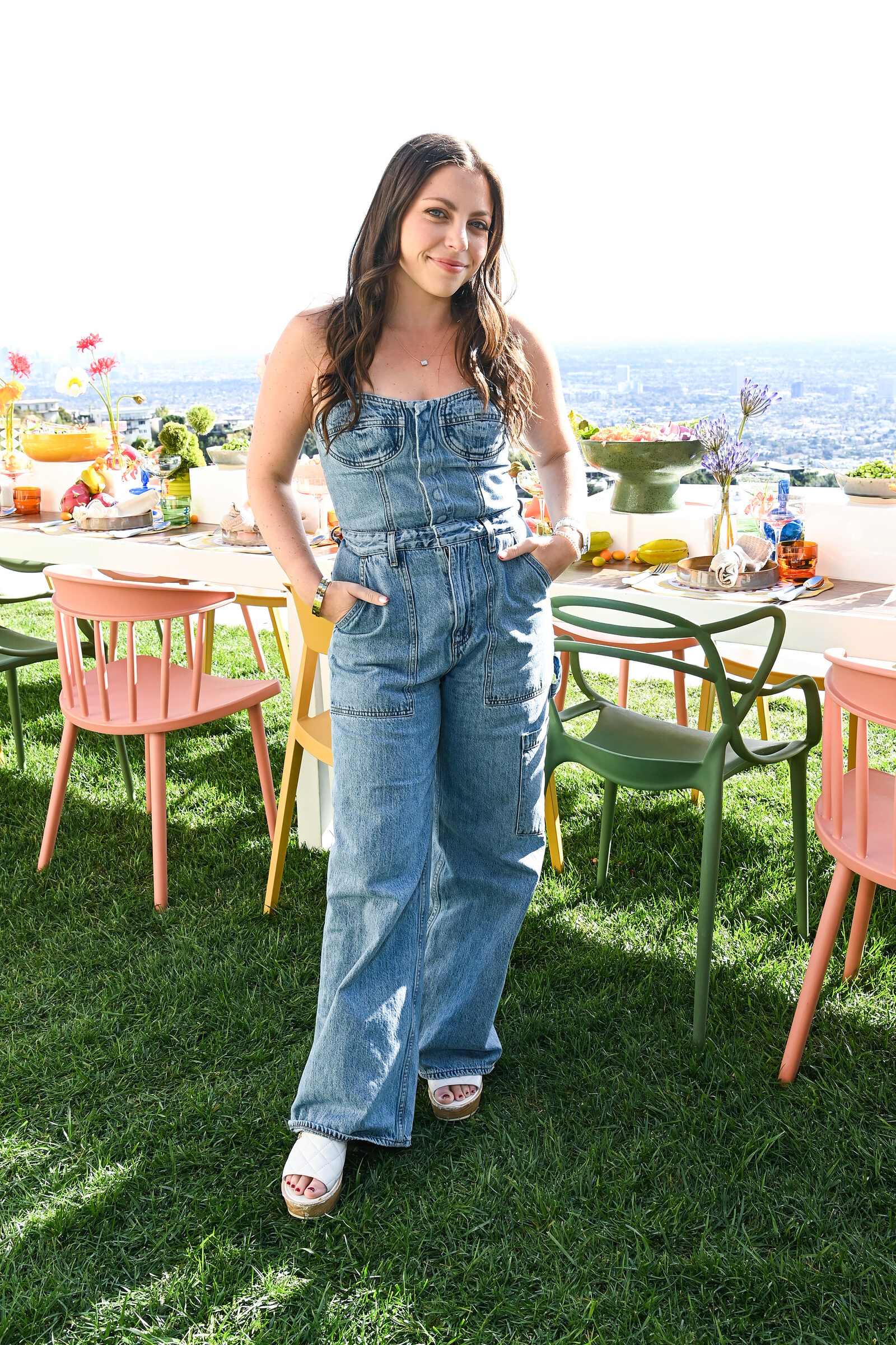 A creator posing at the al fresco lunch table above the Los Angeles skyline