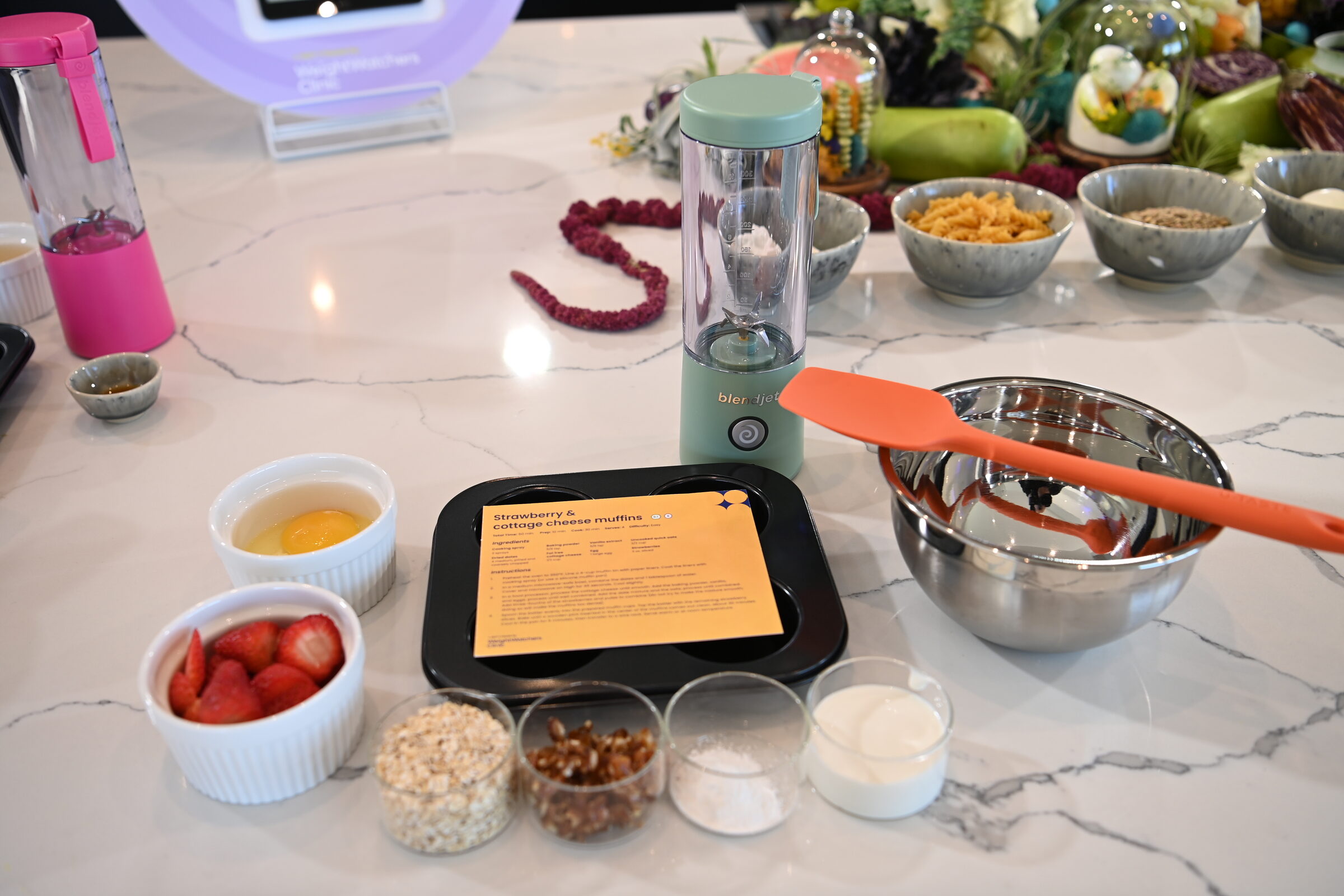 A GLP-1 plan recipe card beside pre-portioned ingredients at a baking station